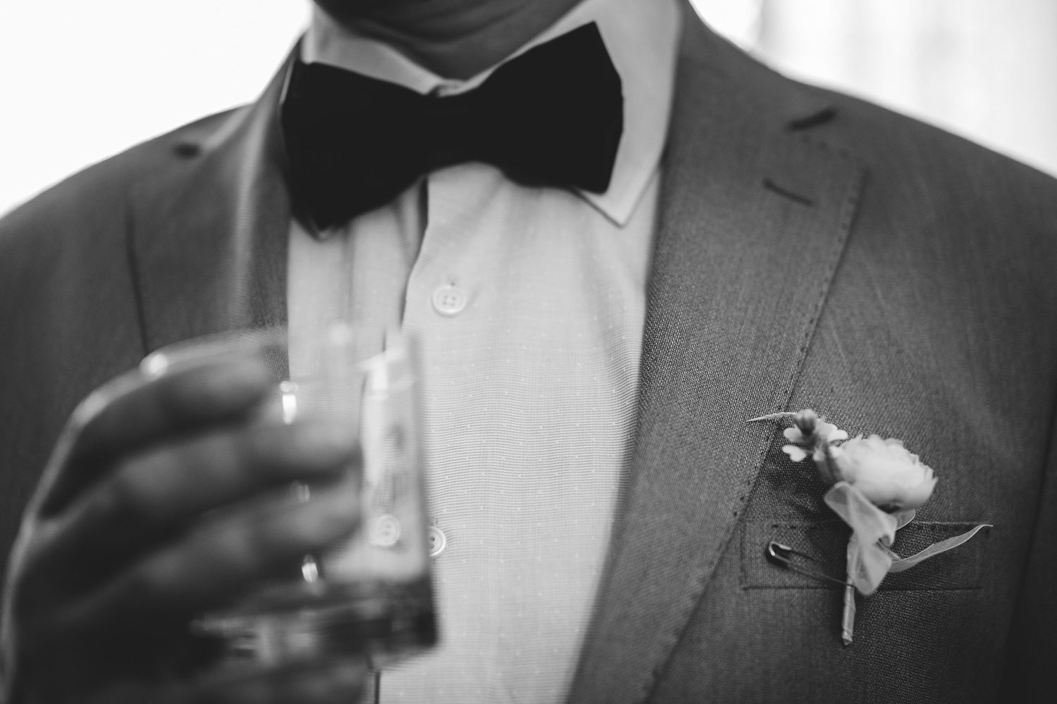 Close-up details of formal wedding attire including bow ties and suits.