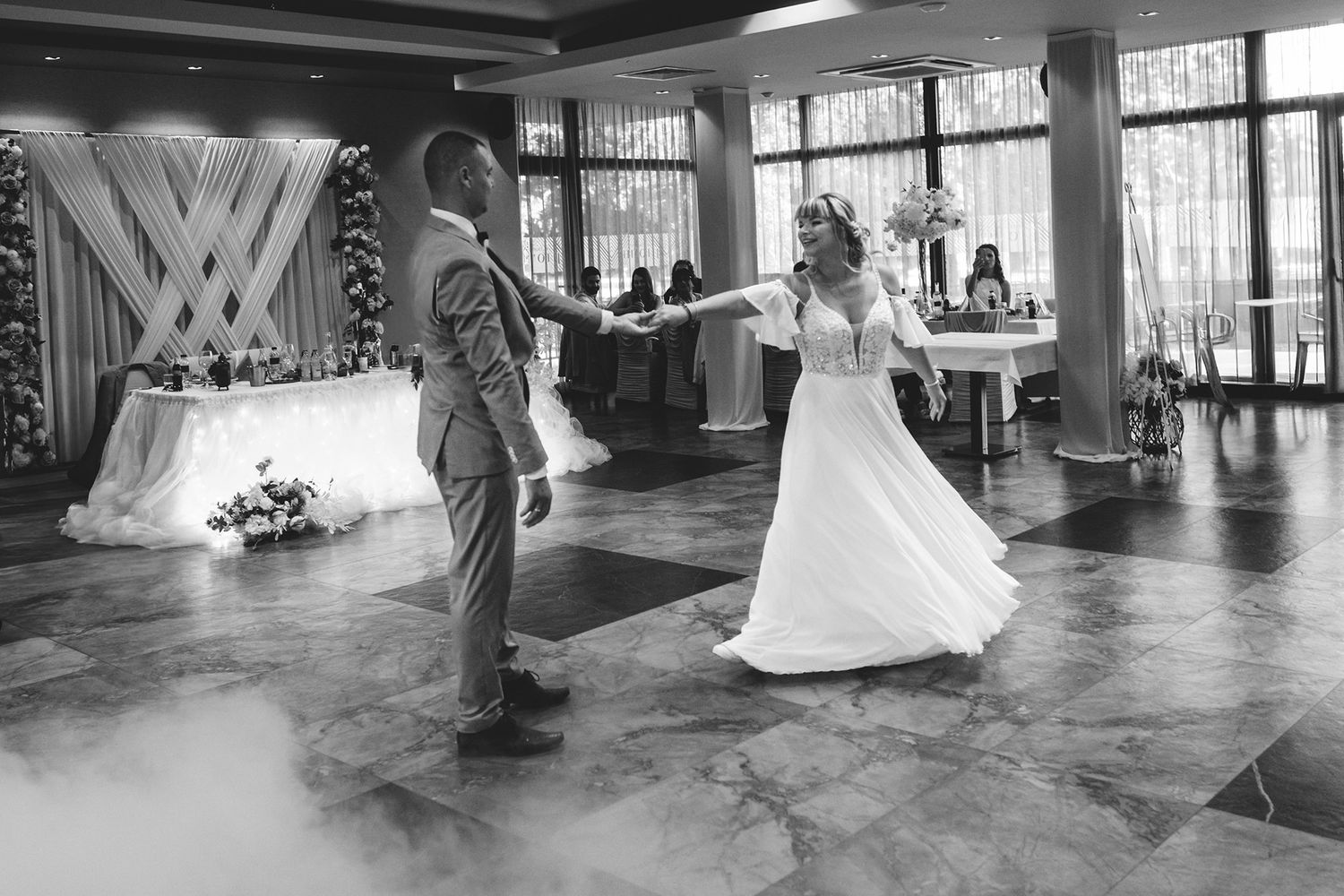 Wedding ceremony venue with large windows and elegant decor setup.