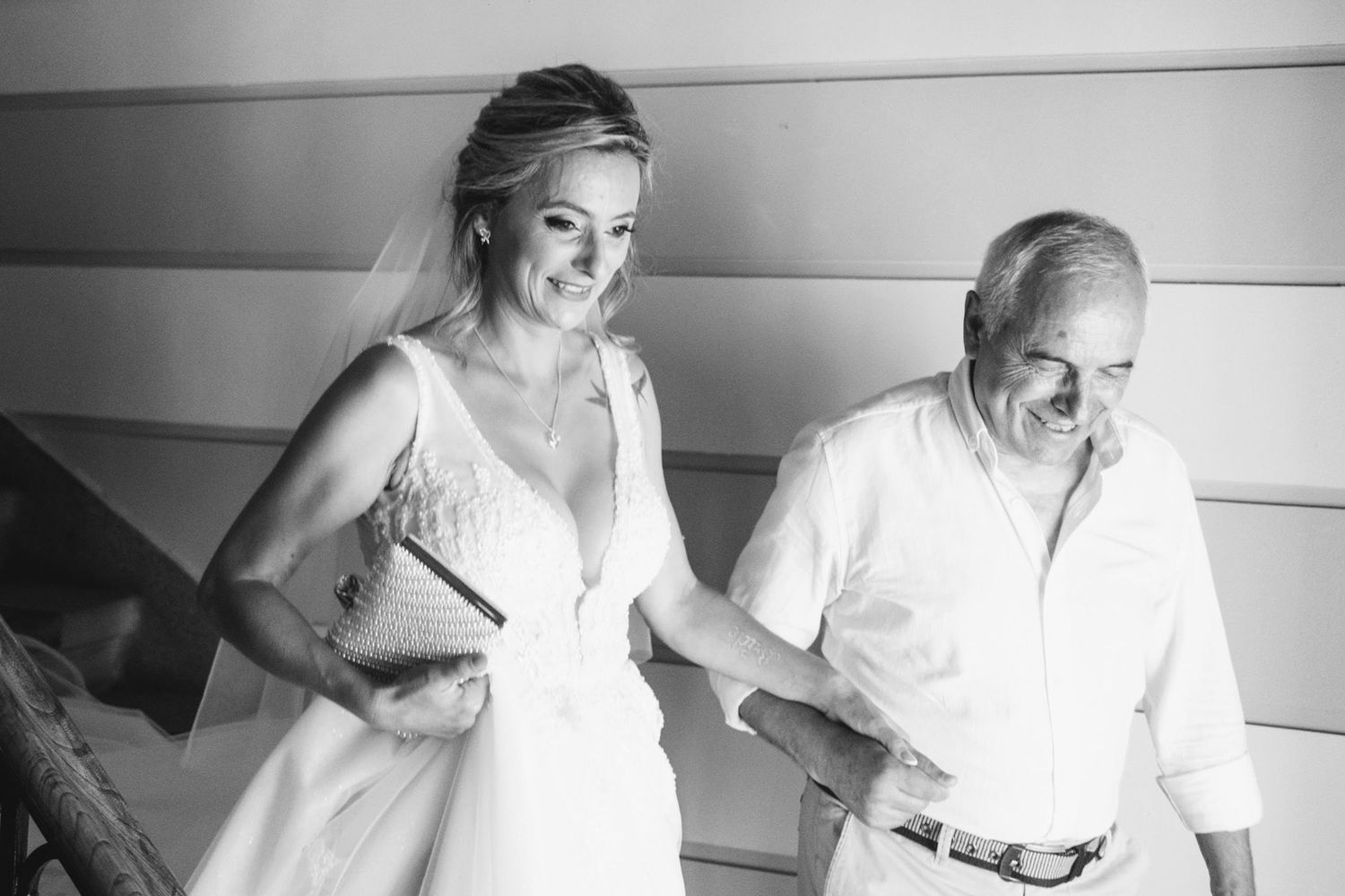 Black and white candid moment captured during wedding preparations.