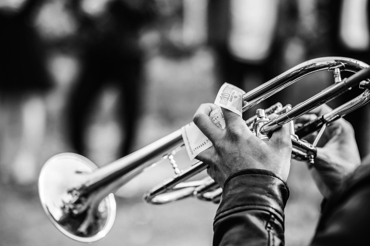 Detail shots of brass musical instruments in black and white.