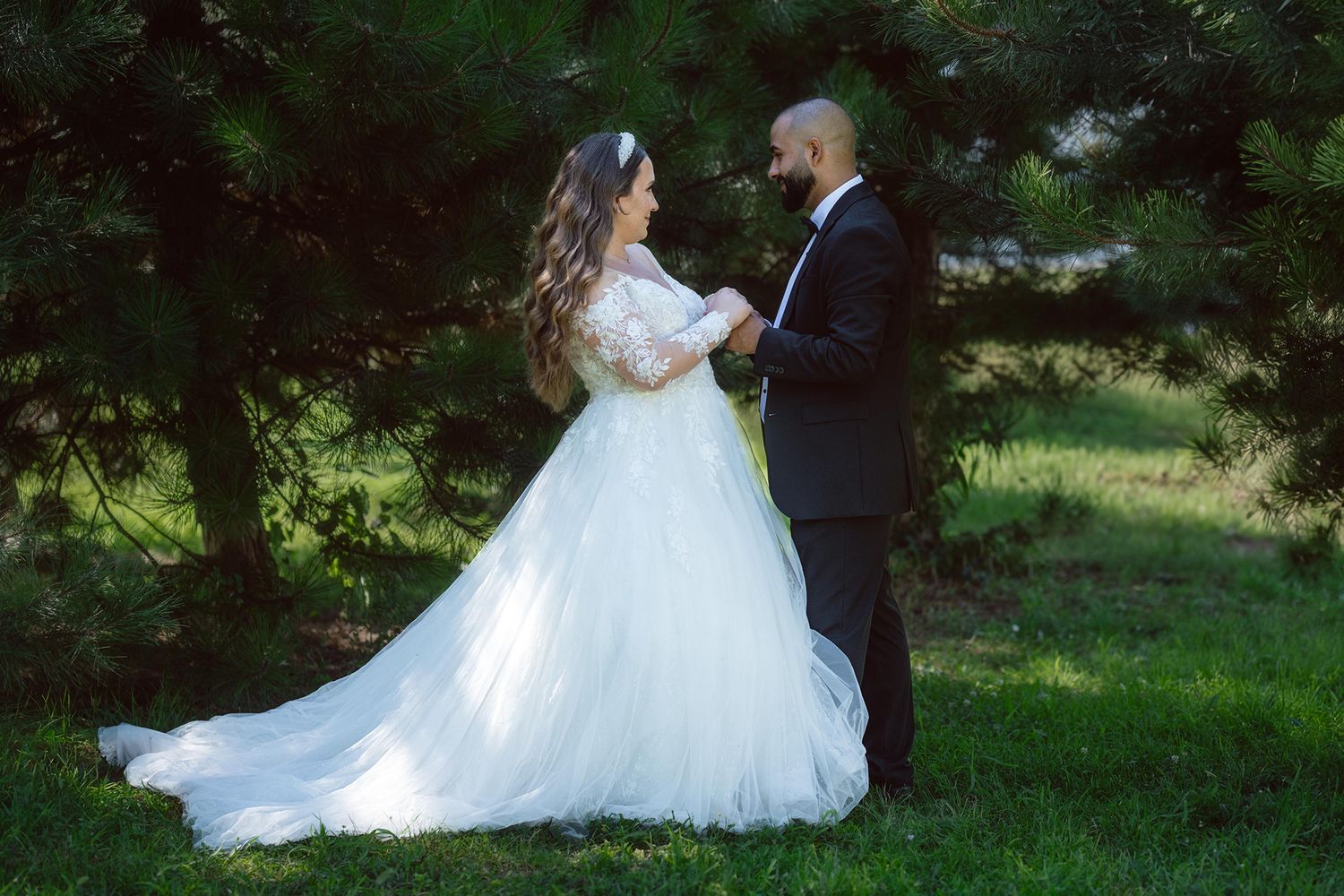 Romantic outdoor wedding portraits taken in a lush garden setting.