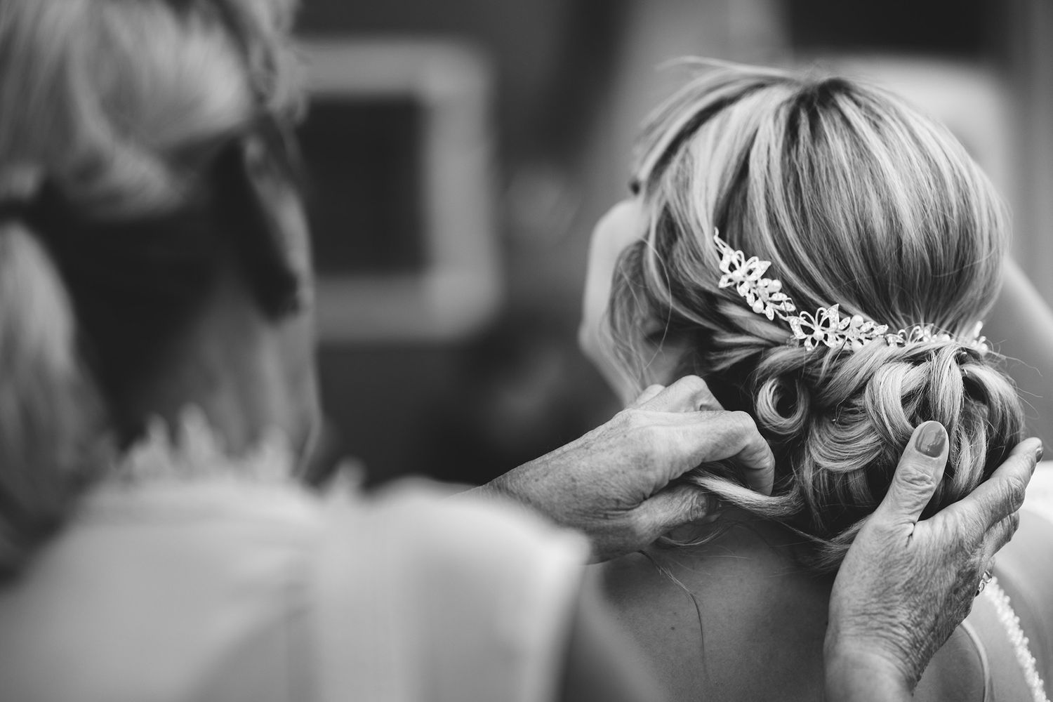 Close-up shots of wedding hair styling and accessories in black and white.
