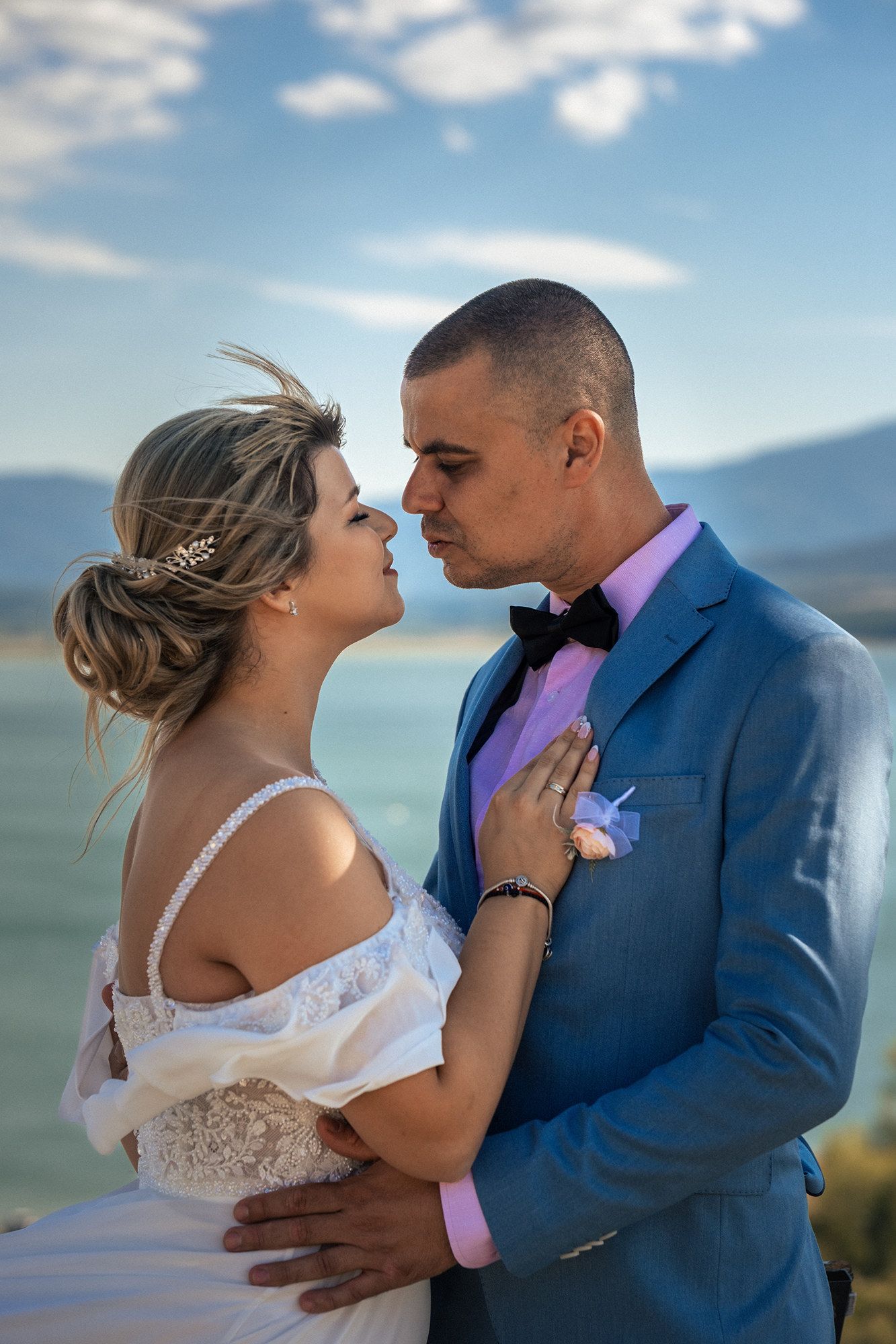 A romantic wedding photoshoot against a scenic mountain backdrop.