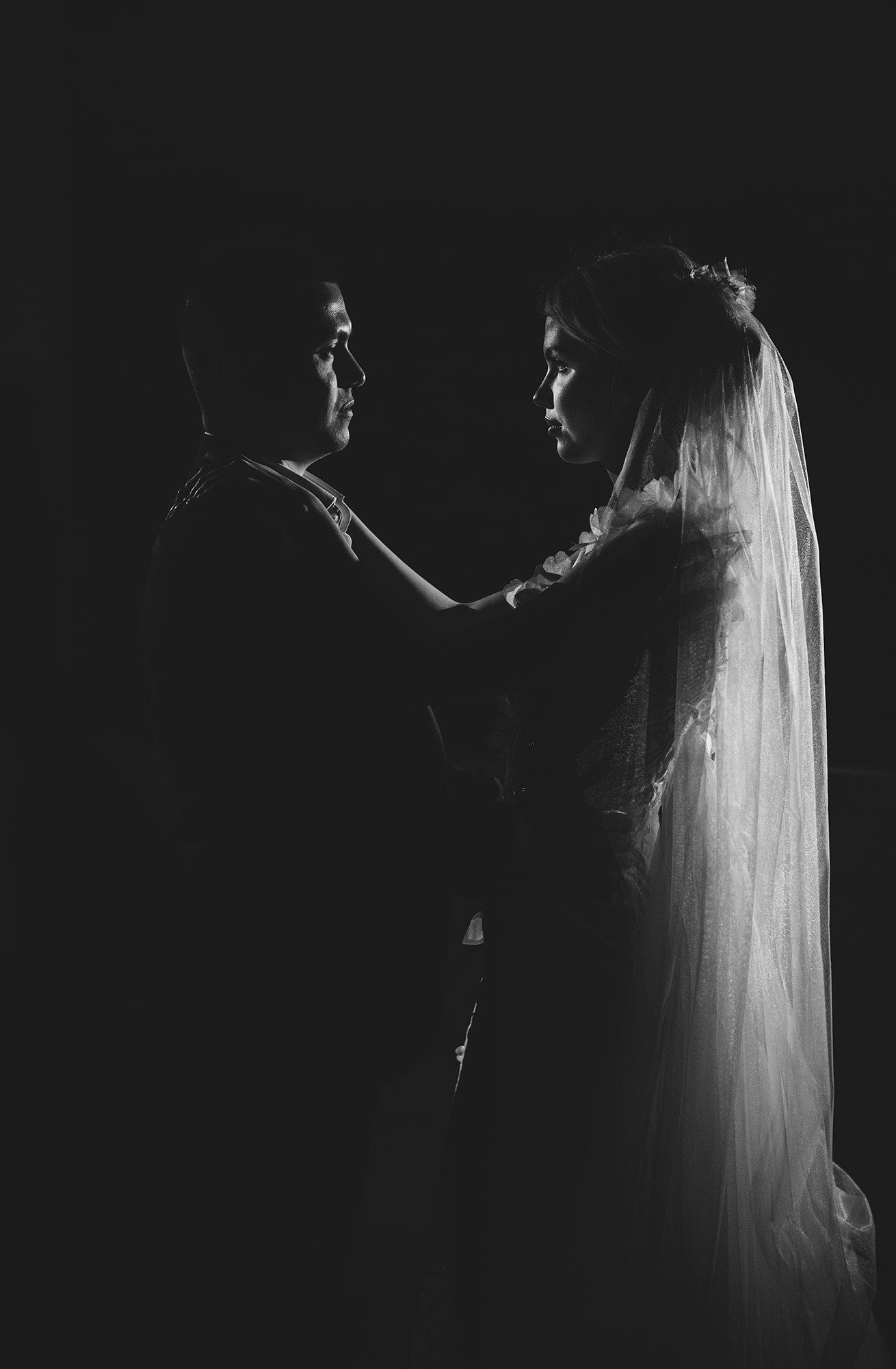 Artistic black and white silhouettes create dramatic wedding photography.