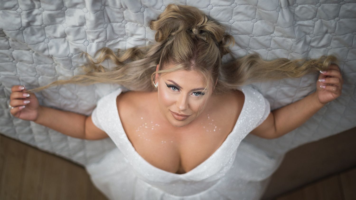 Bride in white wedding dress getting ready before the ceremony.