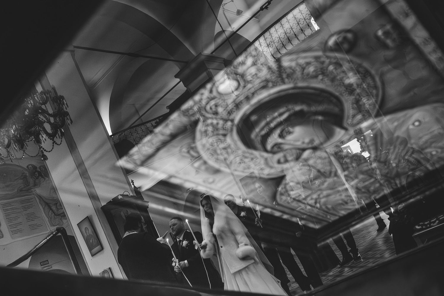 Artistic ceiling detail shot showing ornate architectural elements in dramatic lighting.