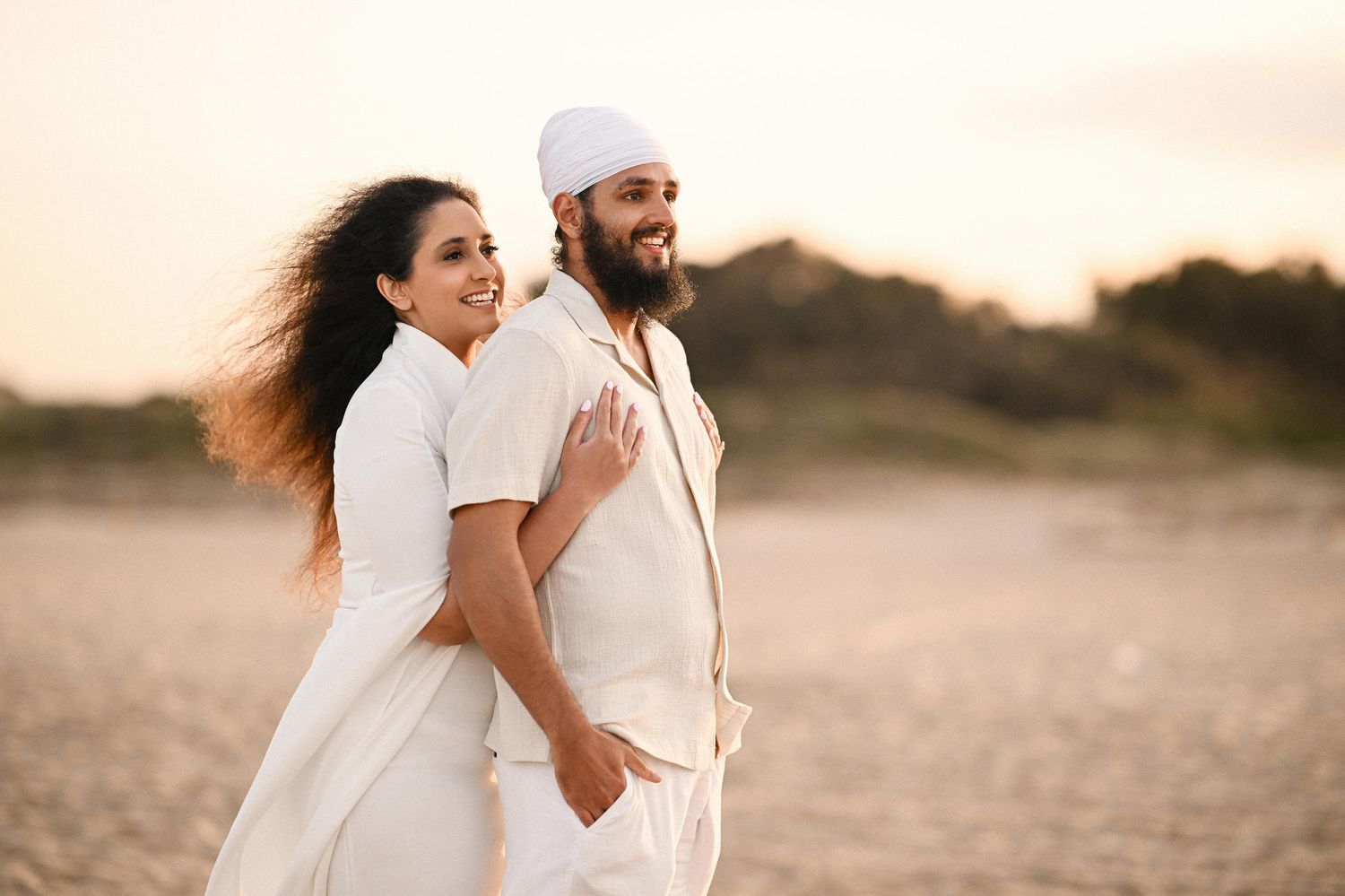Newly engaged couple hugging and laughing on the beach right after the proposal - emotional proposal Valencian photography and videography