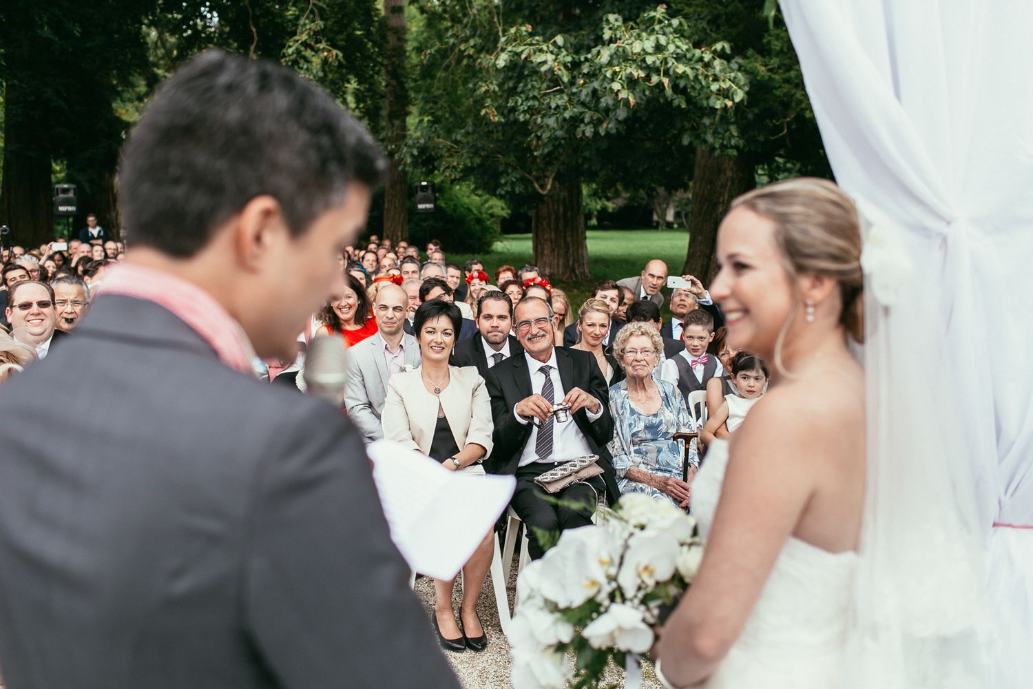 Atmospheric reportage of a wedding ceremony at Château de Changy. Emotional storytelling featuring the historic castle facade
