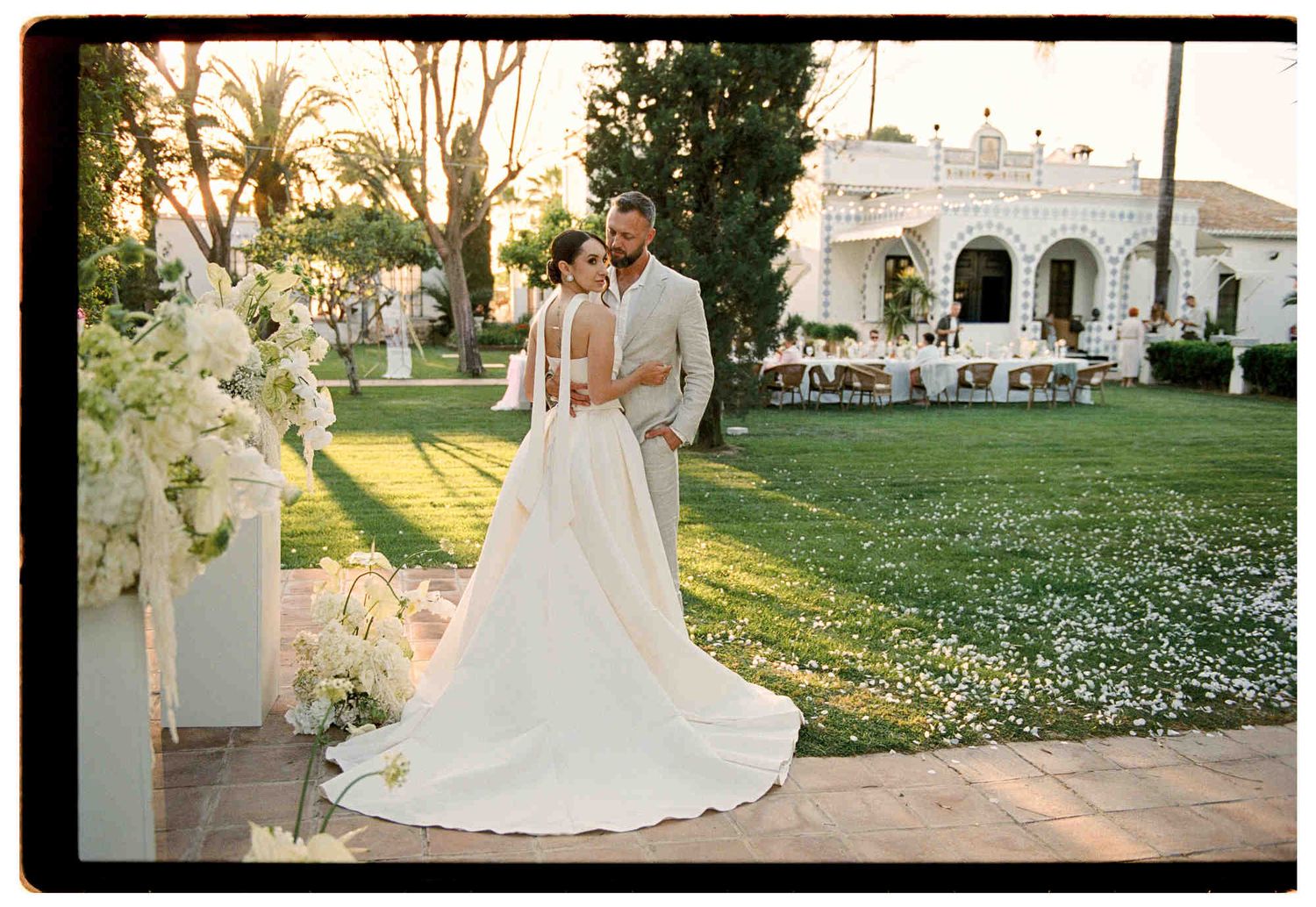 Newlyweds walking to the dinner table after the ceremony at a European wedding - 35mm film photographer in Europe capturing authentic moment