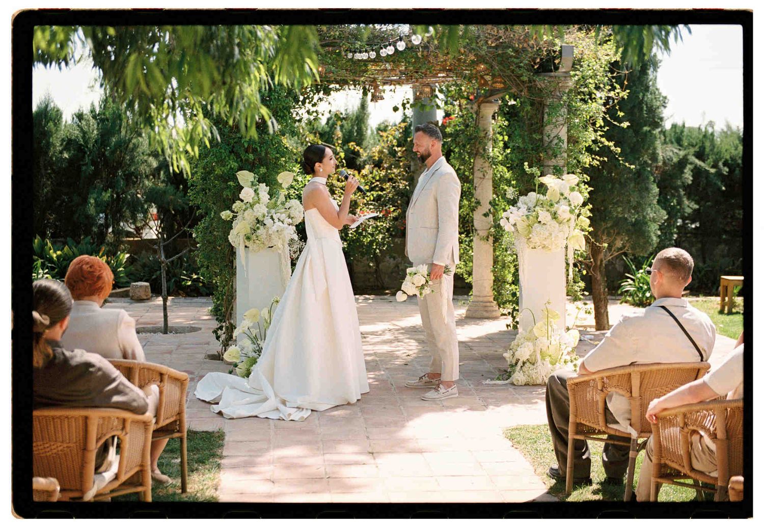 Newlyweds standing at their wedding ceremony at a luxury Valencia villa - professional 35mm film photography in Spain