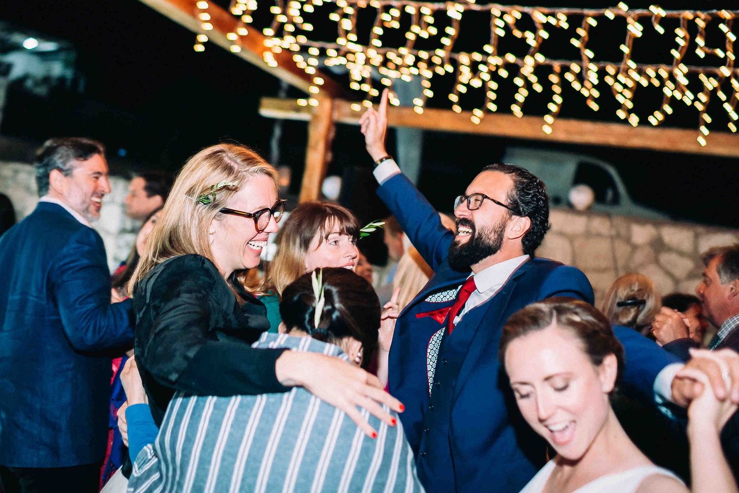 Romantic moment of the bride and groom dancing together under the stars in Milos.