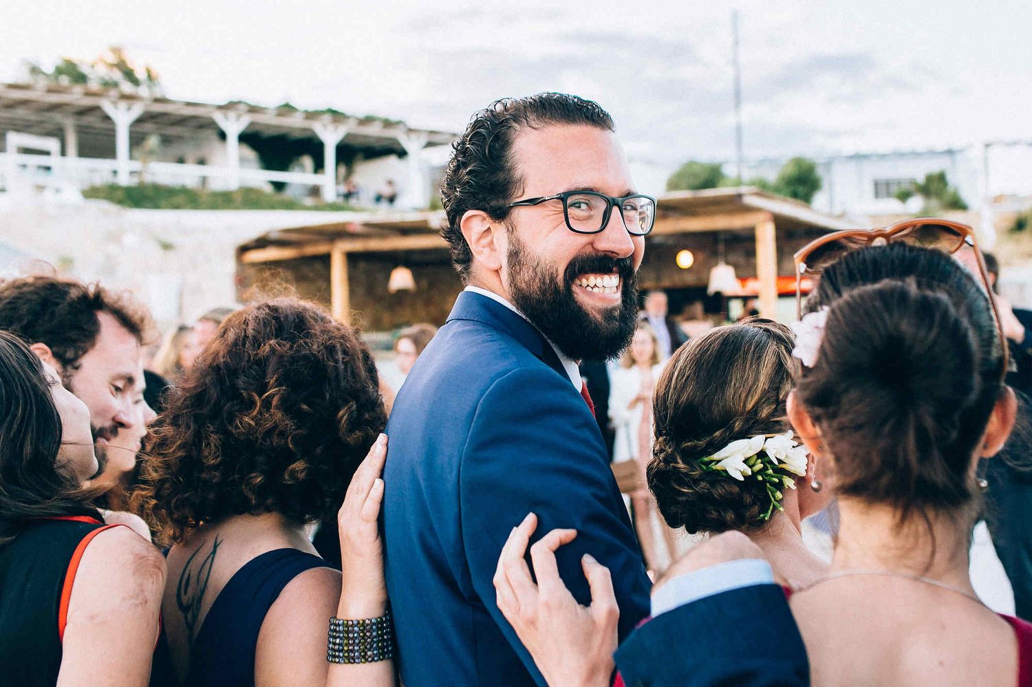 Candid shot of a groom turning towards the European wedding photographer during the ceremony. Real emotions and reportage style.
