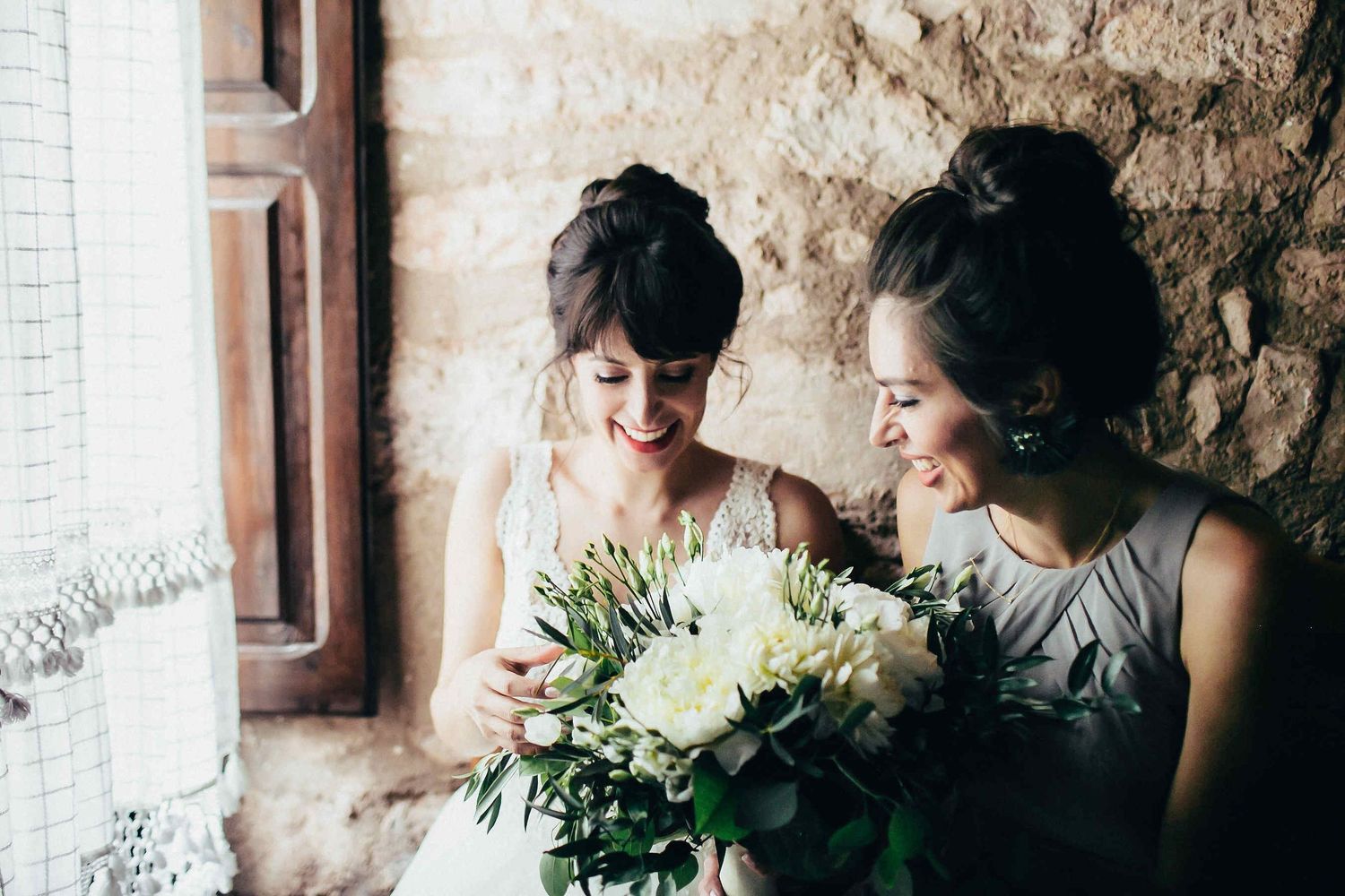 A tender portrait of the bride and her sister during morning preparations. Luxury wedding photography at a private estate near Barcelona