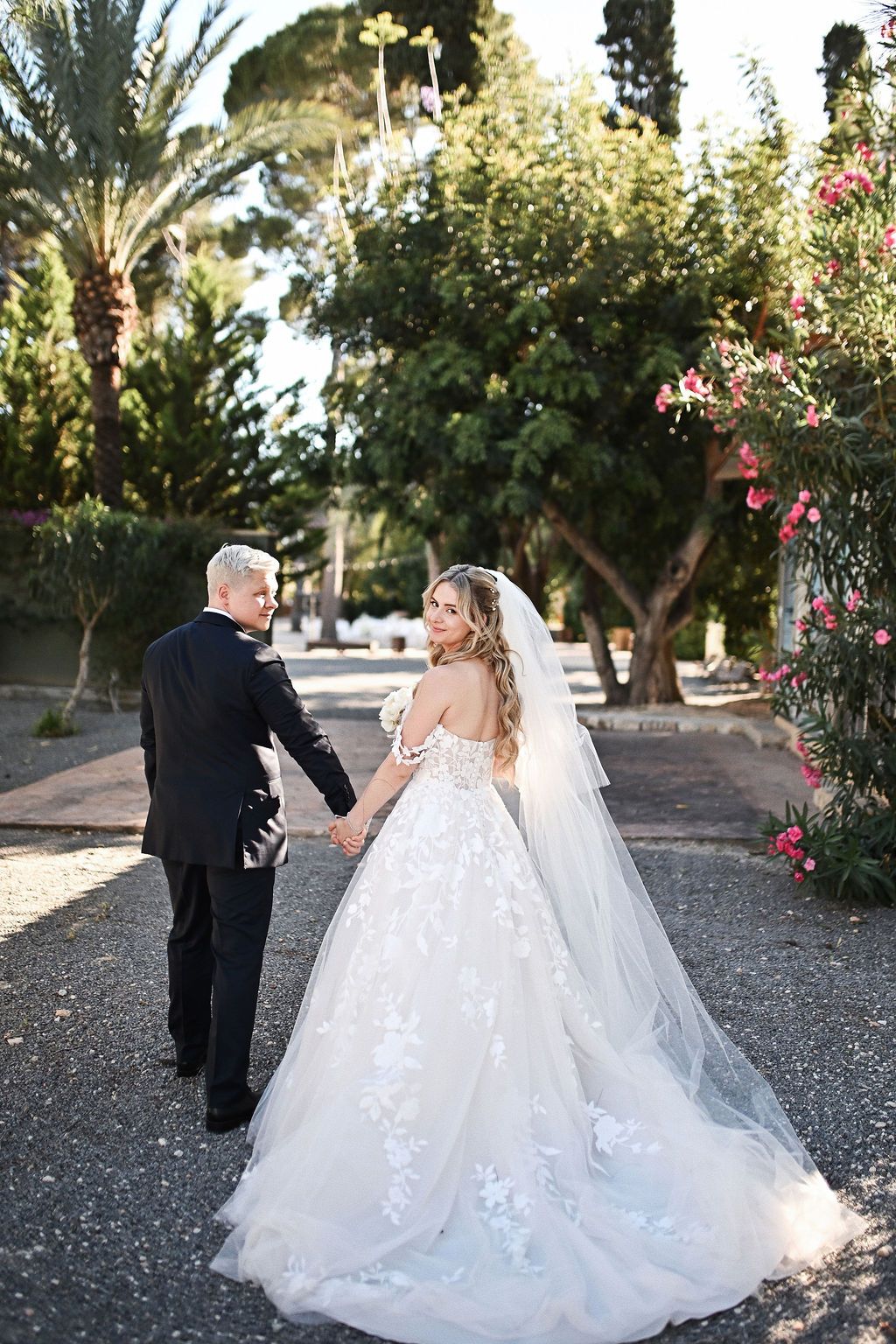 Bride and groom walking through the lush historic estate during their wedding photo session in Benidorm with Darista photographers.