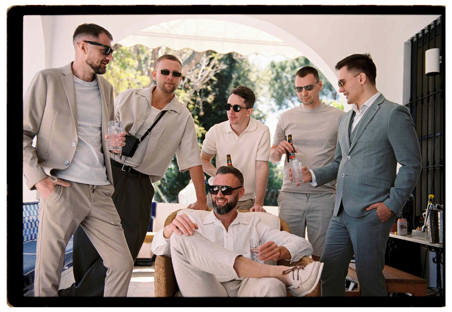 Groom and his friends drinking beer at a luxury Barcelona villa before the ceremony - authentic Kodak Portra 35mm film photography Spain