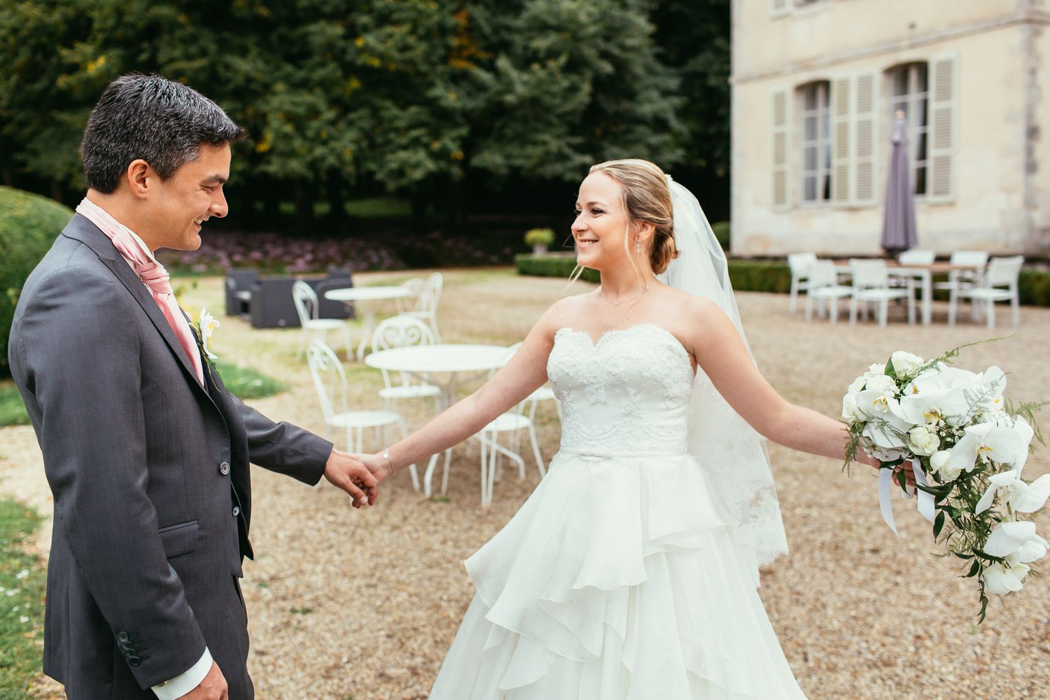 High-fashion bridal portrait in the formal gardens of Château de Changy. Sophisticated aesthetics and historic castle backdrops