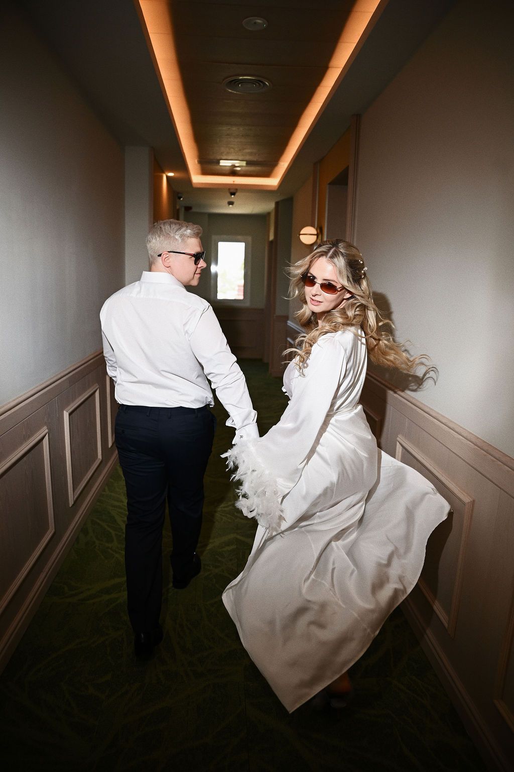 Dynamic direct-flash wedding photography of the couple in a corridor at Barcelo La Nucia Palms. High-fashion Benidorm editorial look.
