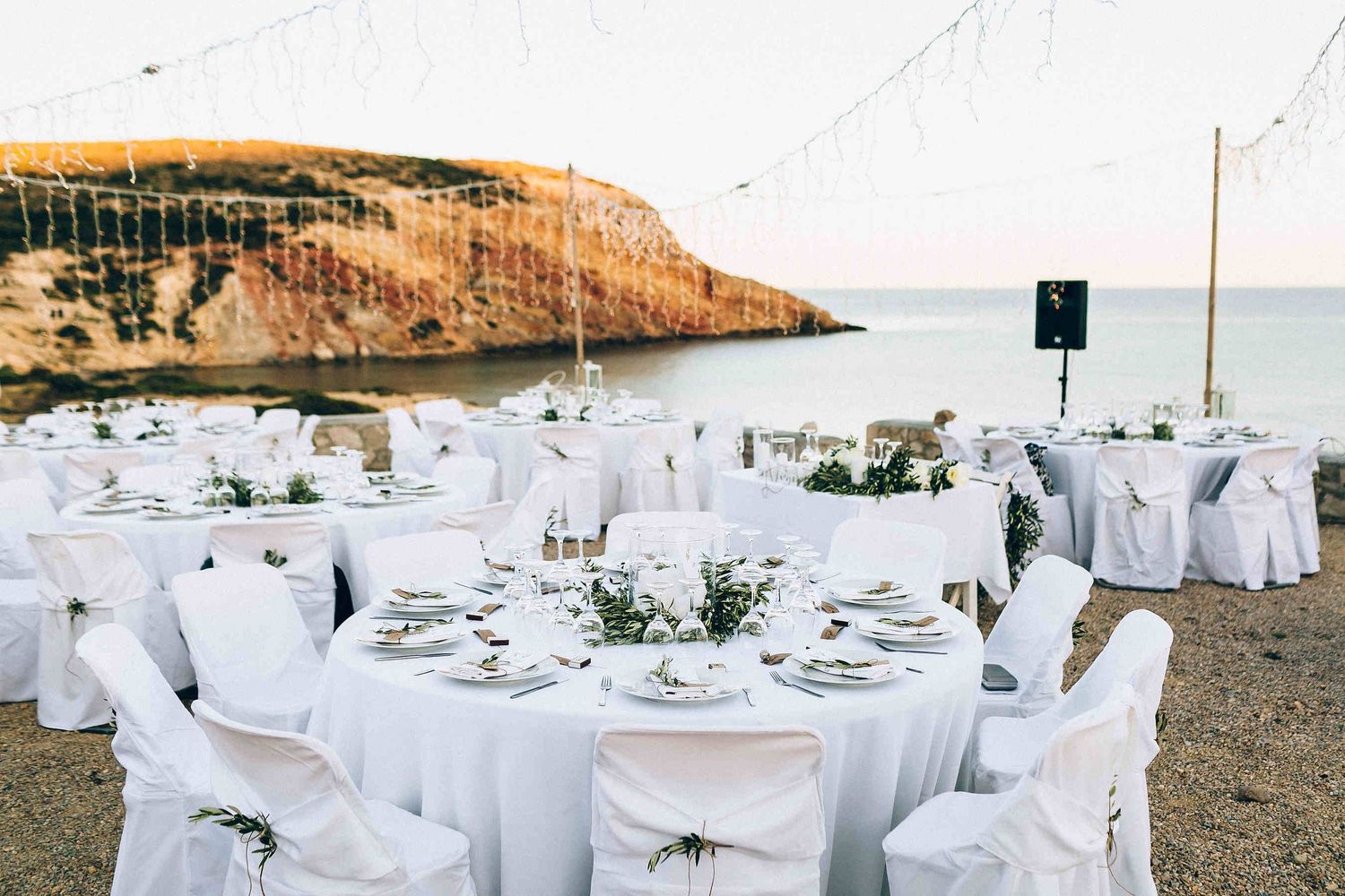 Sophisticated outdoor wedding reception table setting with premium linens and floral arrangements