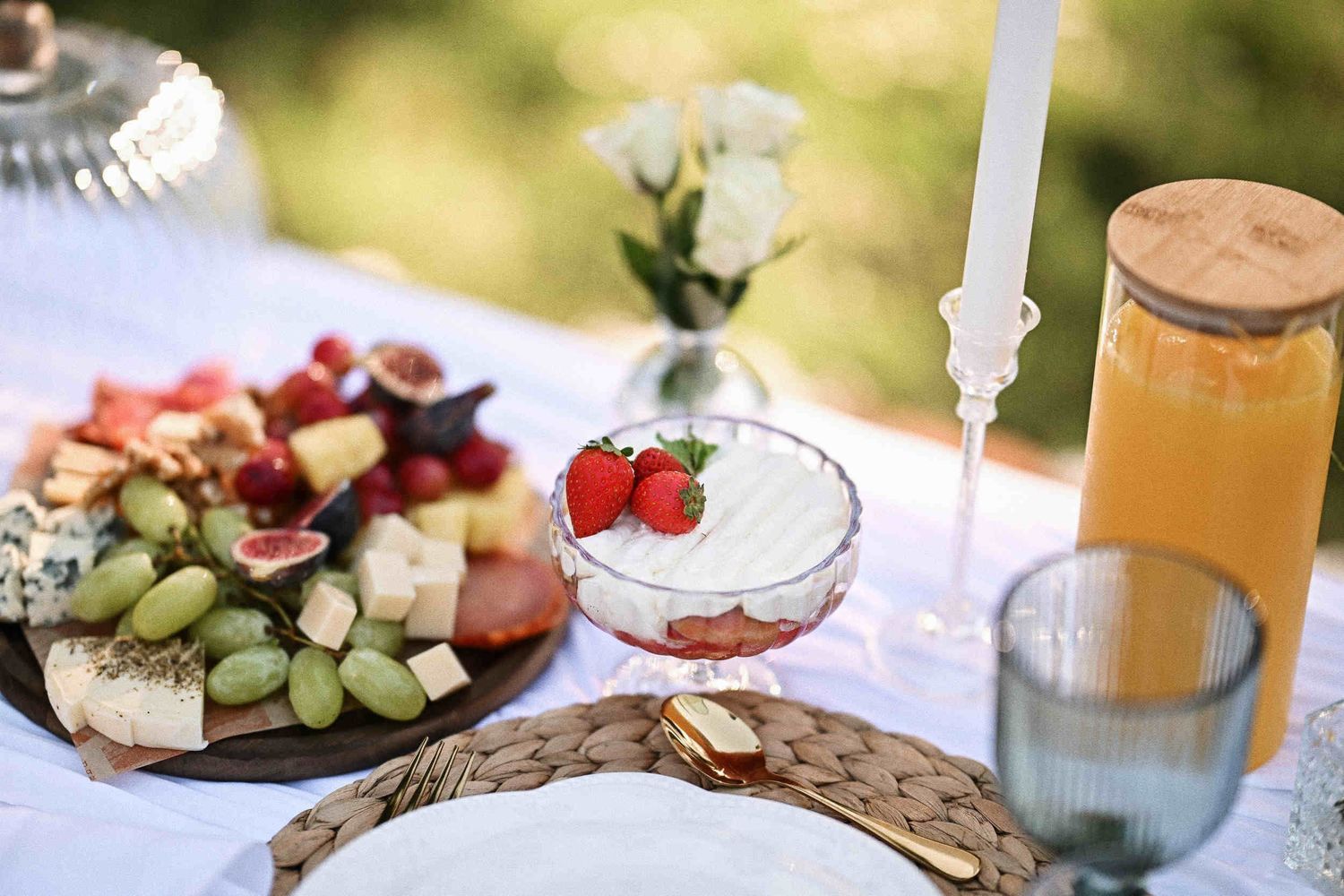 Detailed view of a romantic picnic charcuterie board and fresh strawberries for a marriage proposal.