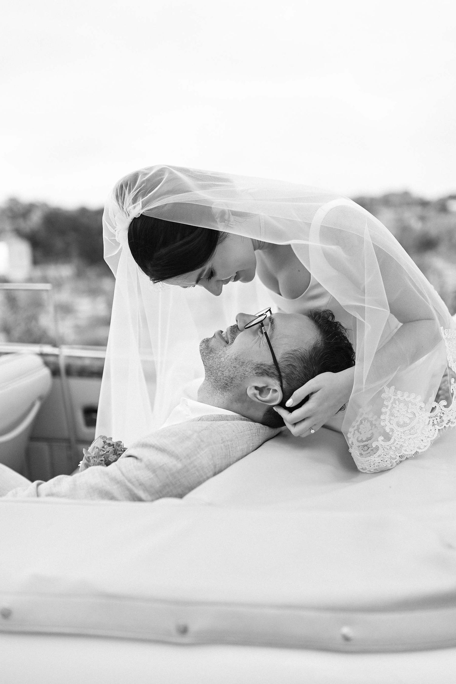 Intimate wedding photography in Spain. A tender moment with the bride leaning over the groom during a quiet, sincere celebration
