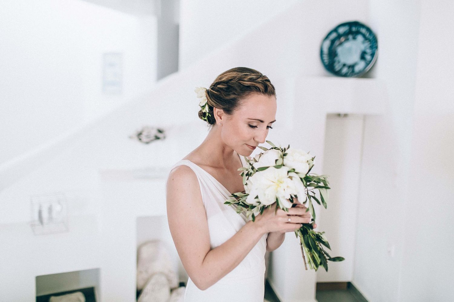 Elegant bride posing with her peony bouquet at the family estate in Milos