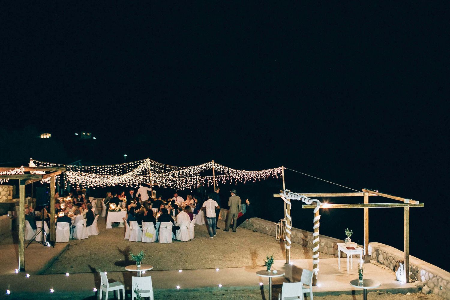 Grand wide-angle view of the illuminated wedding villa at night, concluding the story