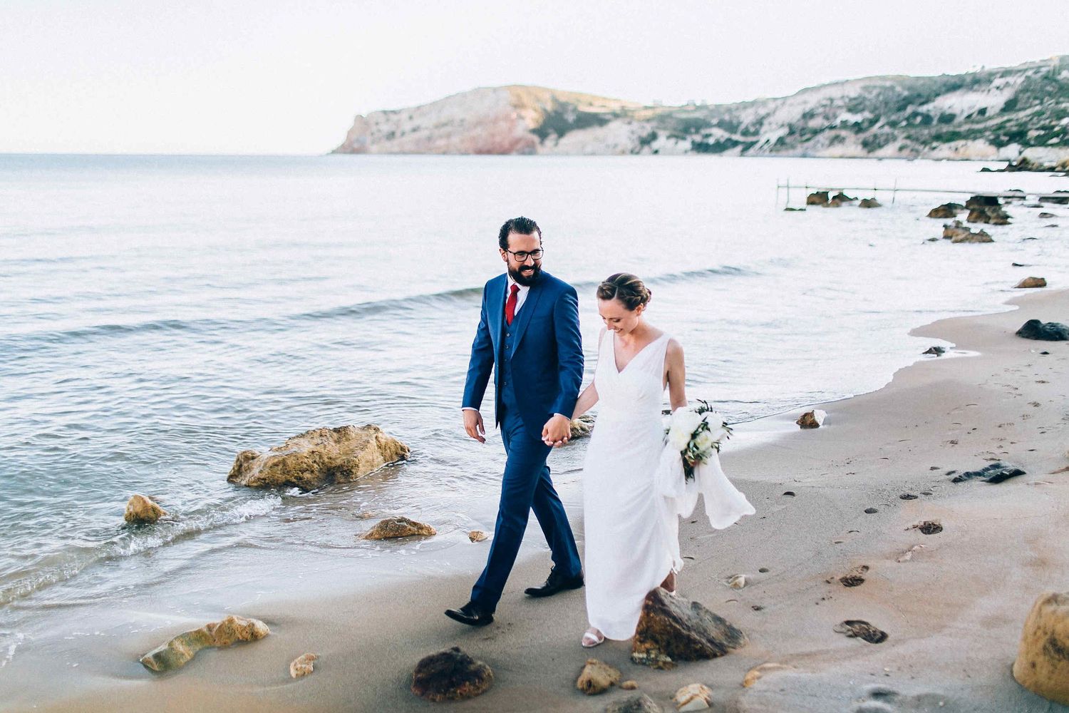 Scenic view of the couple exploring the rugged and beautiful coastline of Milos.