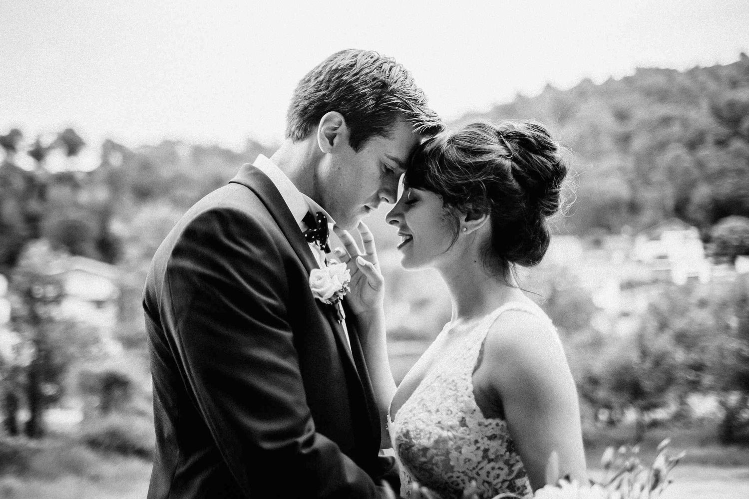A romantic and tender embrace of the bride and groom during their destination wedding at Masia El Follo. Authentic imagery in Catalonia