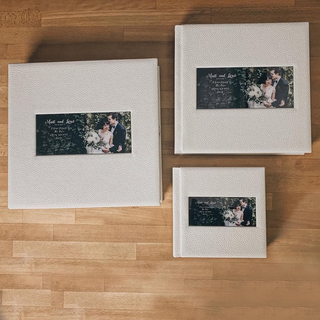 A set of three custom-made wedding albums: one large book for the newlyweds and two smaller versions for their parents.
