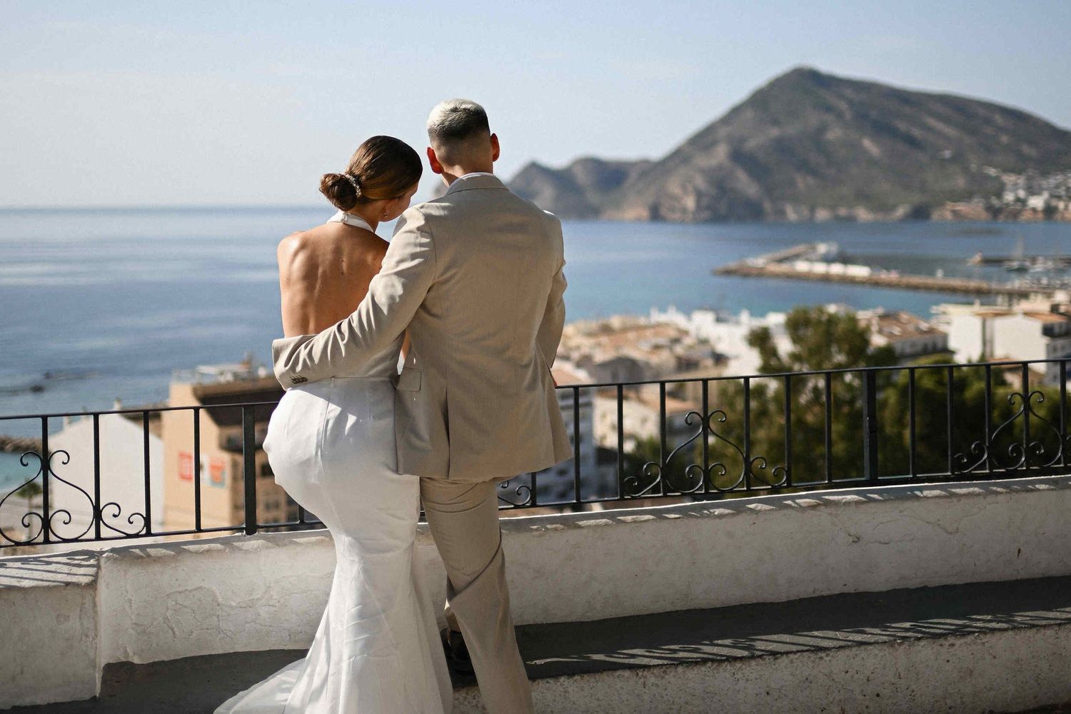 Newlyweds enjoying a panoramic Mediterranean view from an elevated viewpoint during their destination wedding in Costa Blanca