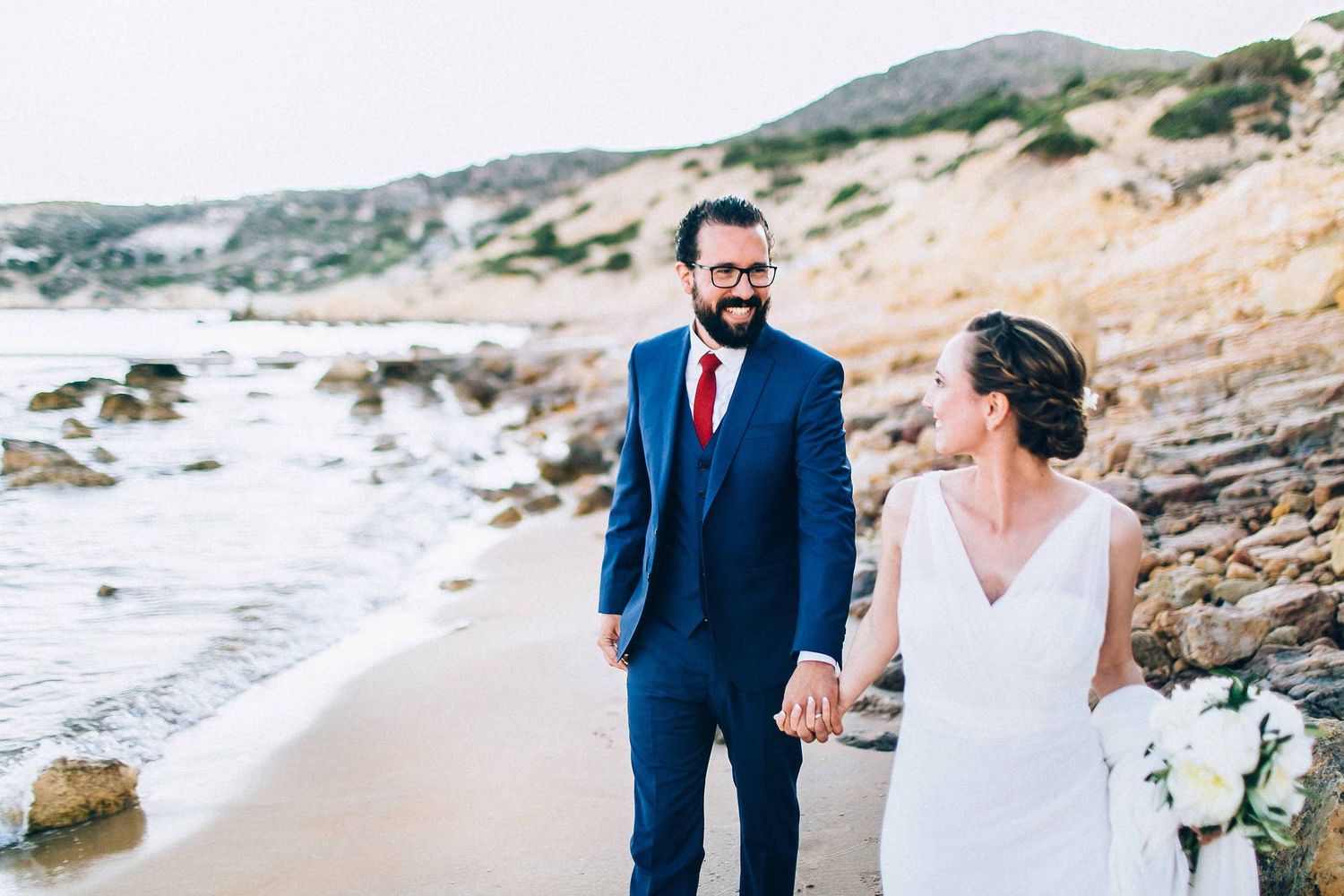 Unposed and natural wedding photography on beach of Milos