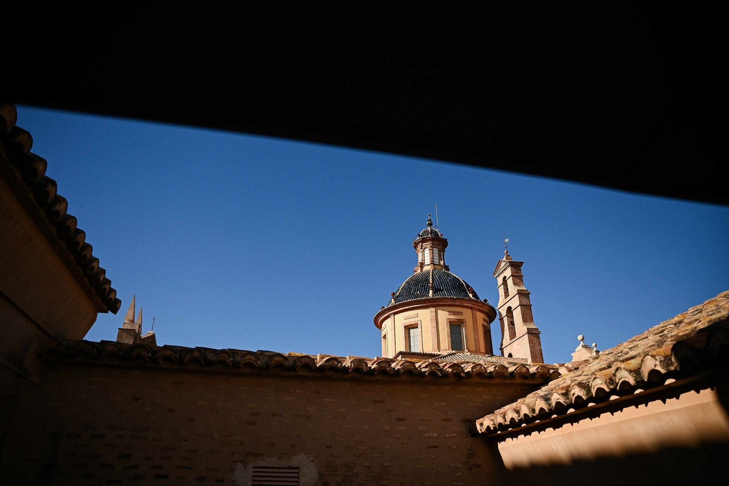 Panoramic rooftop view of the historic La Cartoixa d'Ara Christi during a luxury destination wedding ceremony in Valencia, Spain.