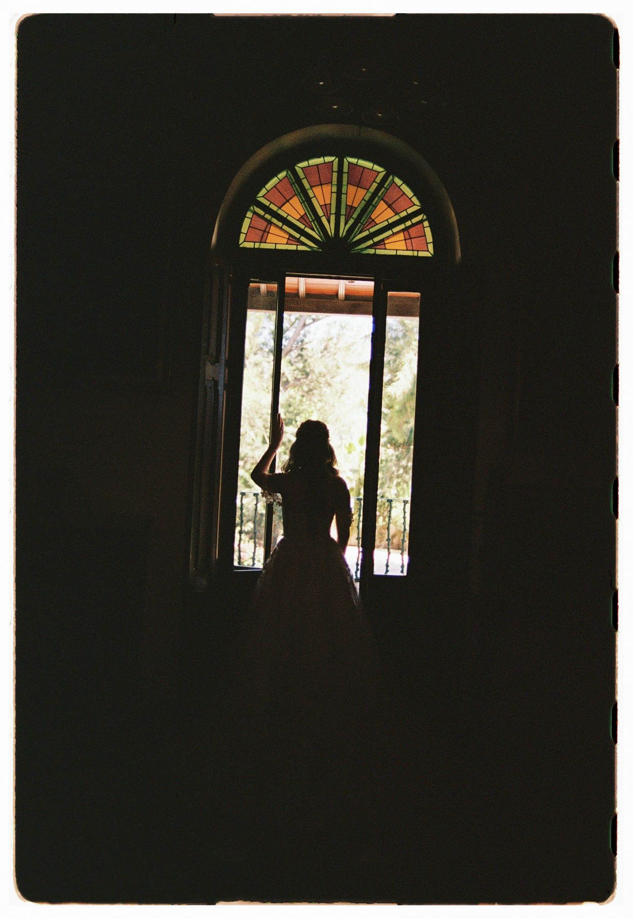 ull-length silhouette of a bride on a balcony, wide shot at Finca El Senyoret wedding venue.
