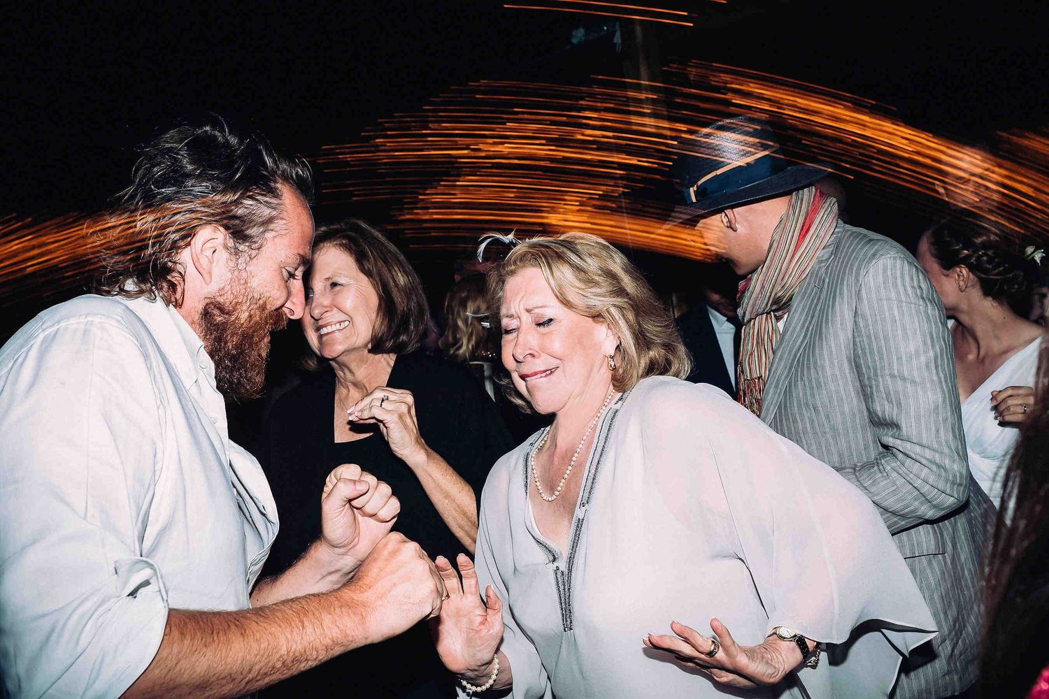 Pure happiness and celebration as wedding guests laugh, smile, and dance the night away