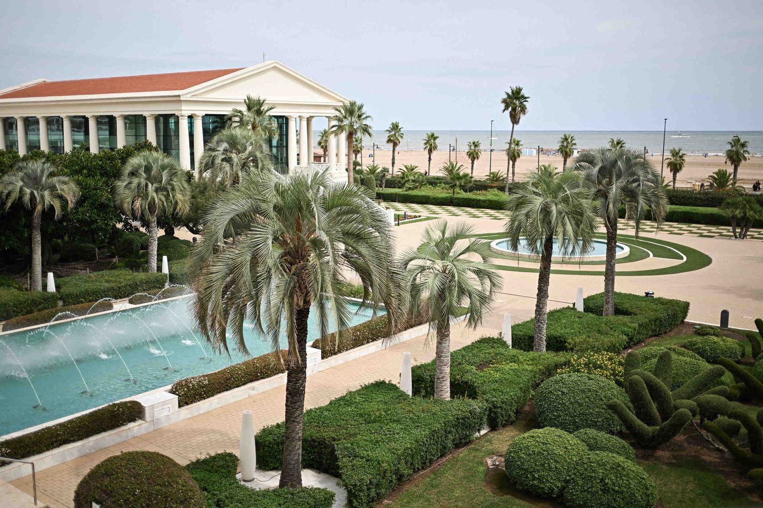 Elevated view of palm gardens, fountains, and classic colonnade at Hotel Las Arenas Balneario Resort Valencia