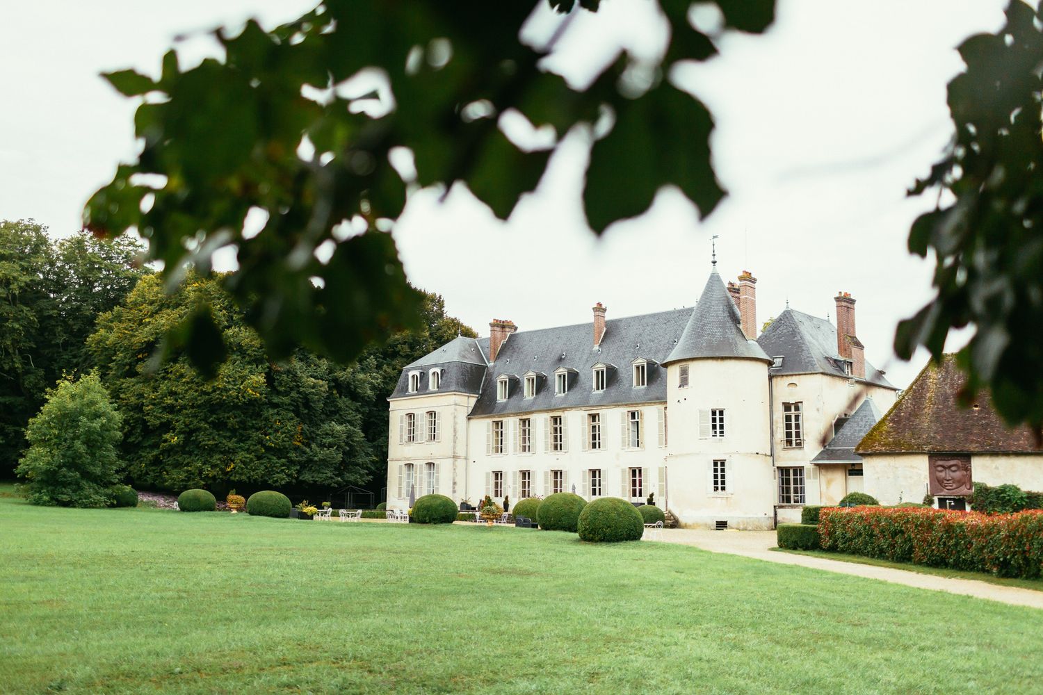 Exterior view of Château de Changy during a luxury wedding. Timeless French castle architecture and editorial vibe