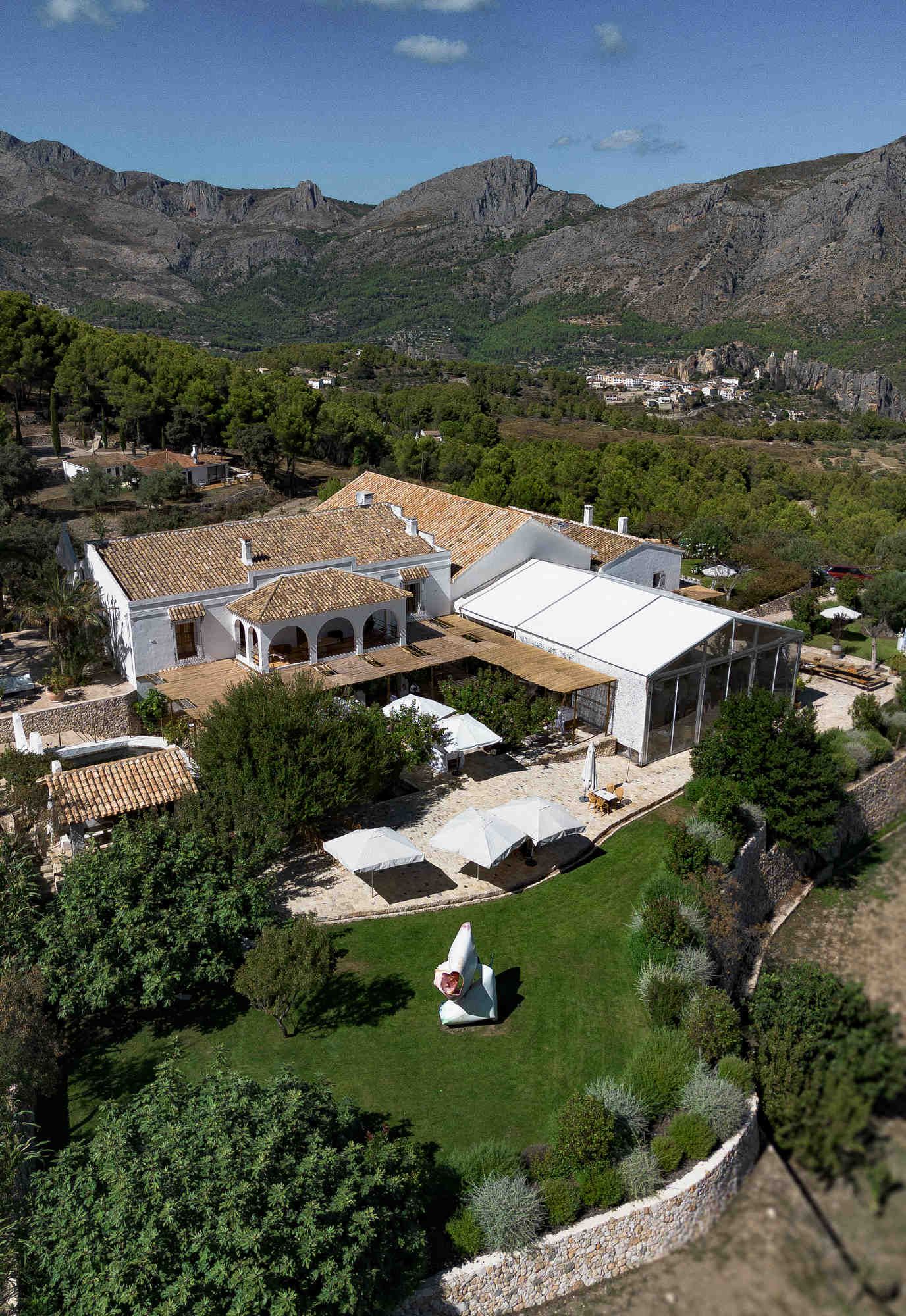 Aerial view of Bodega MASOS estate nestled in the Guadalest Valley surrounded by mountains