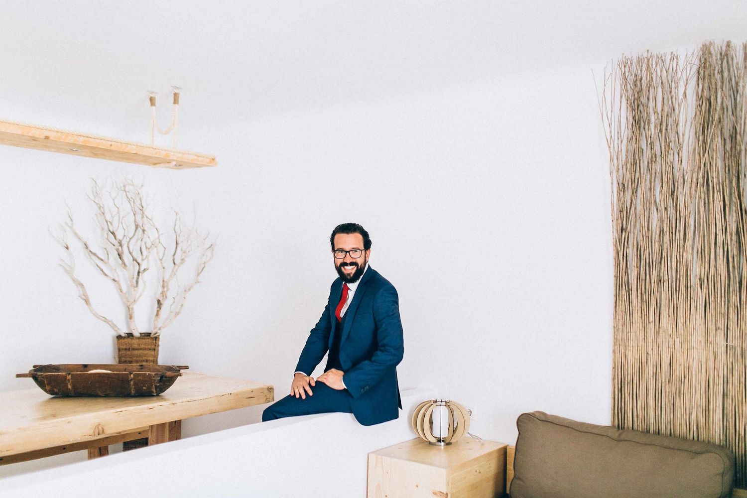 Artistic reflection of the groom preparing for his ceremony at a luxury Milos hotel
