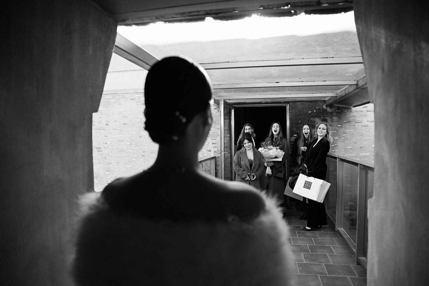 Emotional first look moment as the bride reveals her gown to friends, captured in a documentary editorial style by Darista Wedding.