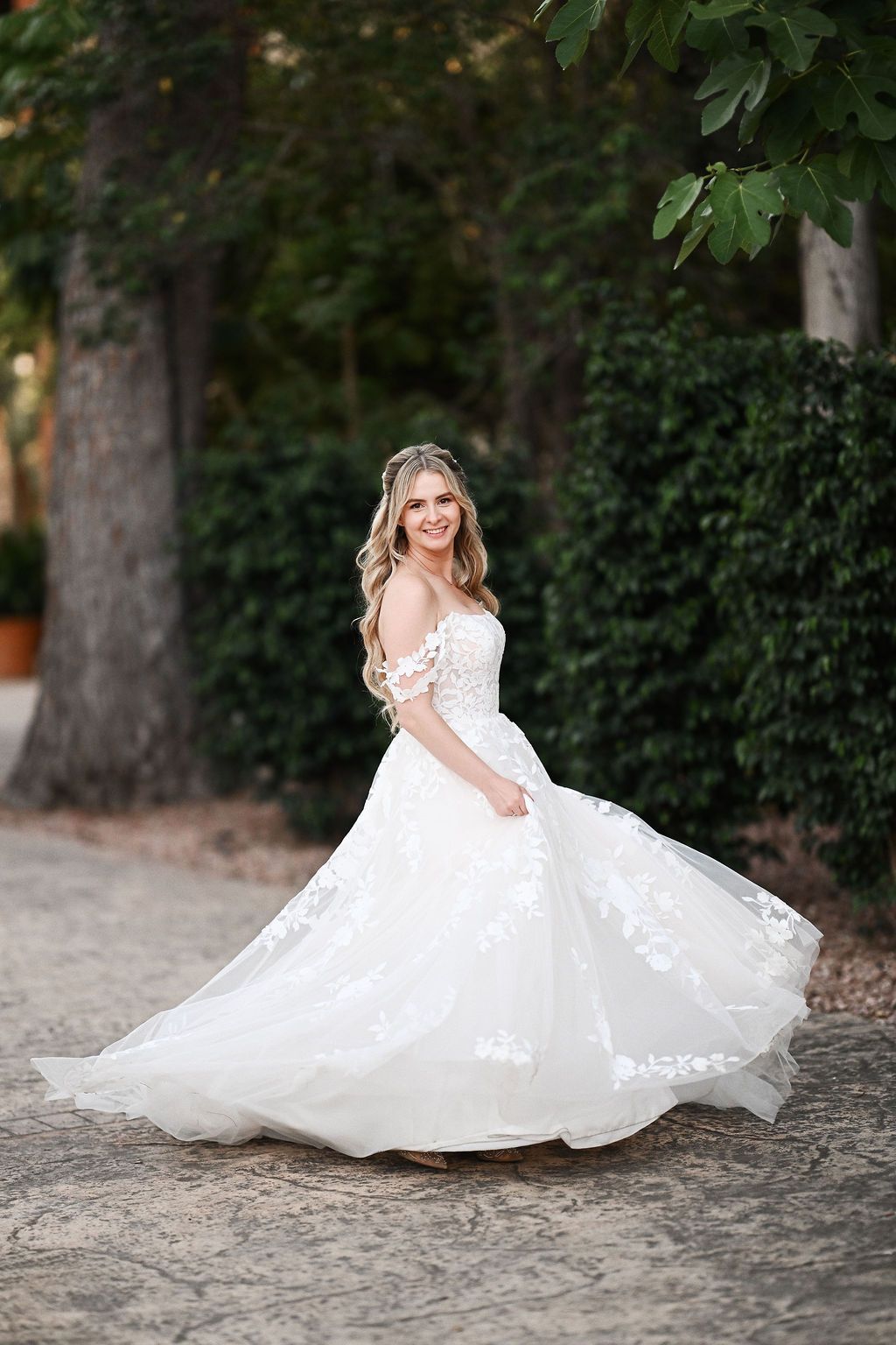 The bride twirling in her stunning Pronovias wedding dress, showing the long train at Finca El Senyoret. Benidorm photo by Darista.