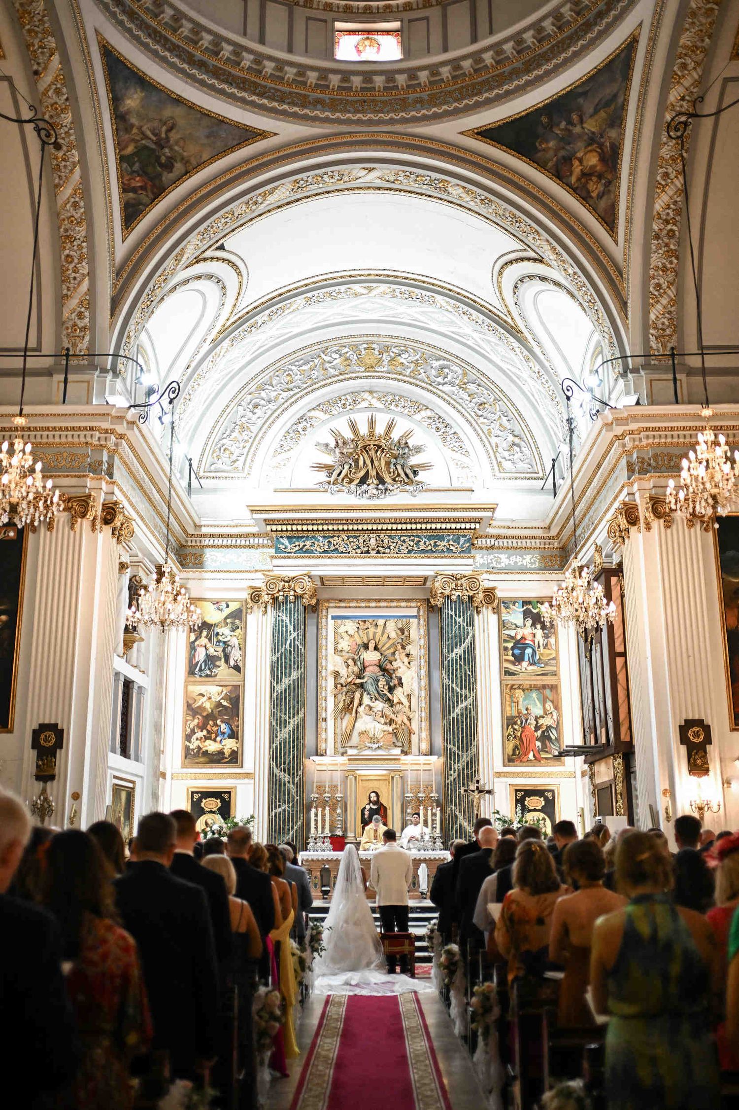 Panoramic view of a Catholic wedding ceremony at Parroquia de Santa Maria del Mar with guests in pews.
