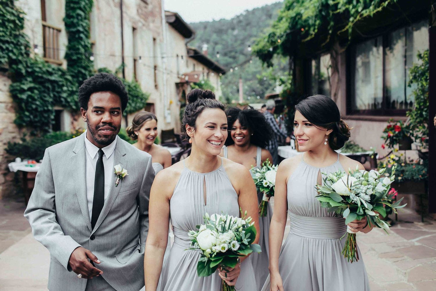 Bridesmaids walking through Catalonia streets to the ceremony during a luxury destination wedding in Barcelona