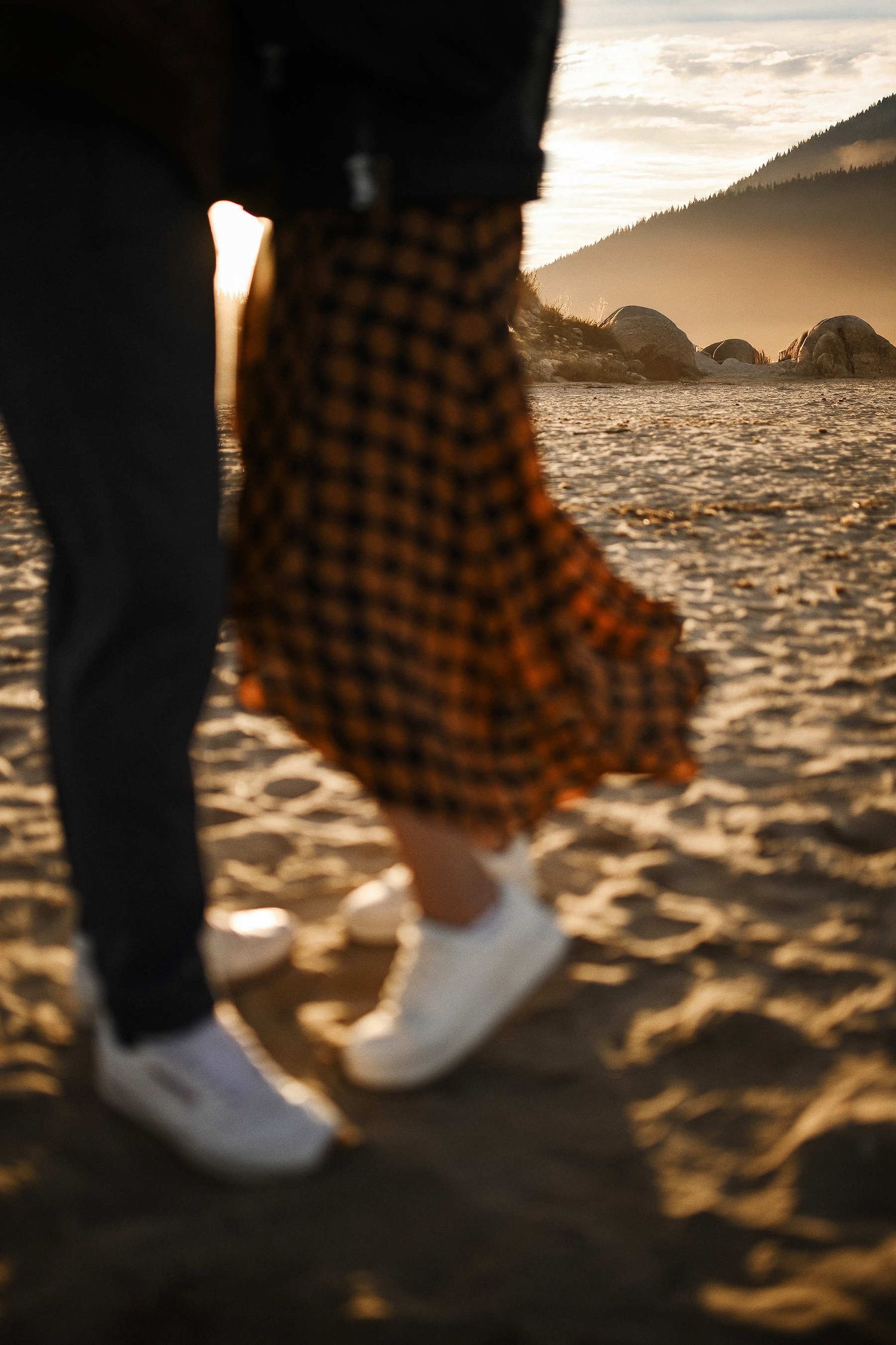 Atmospheric shot of beach vegetation and sand with the engaged couple out of focus in the background during surpise proposal in Valencia