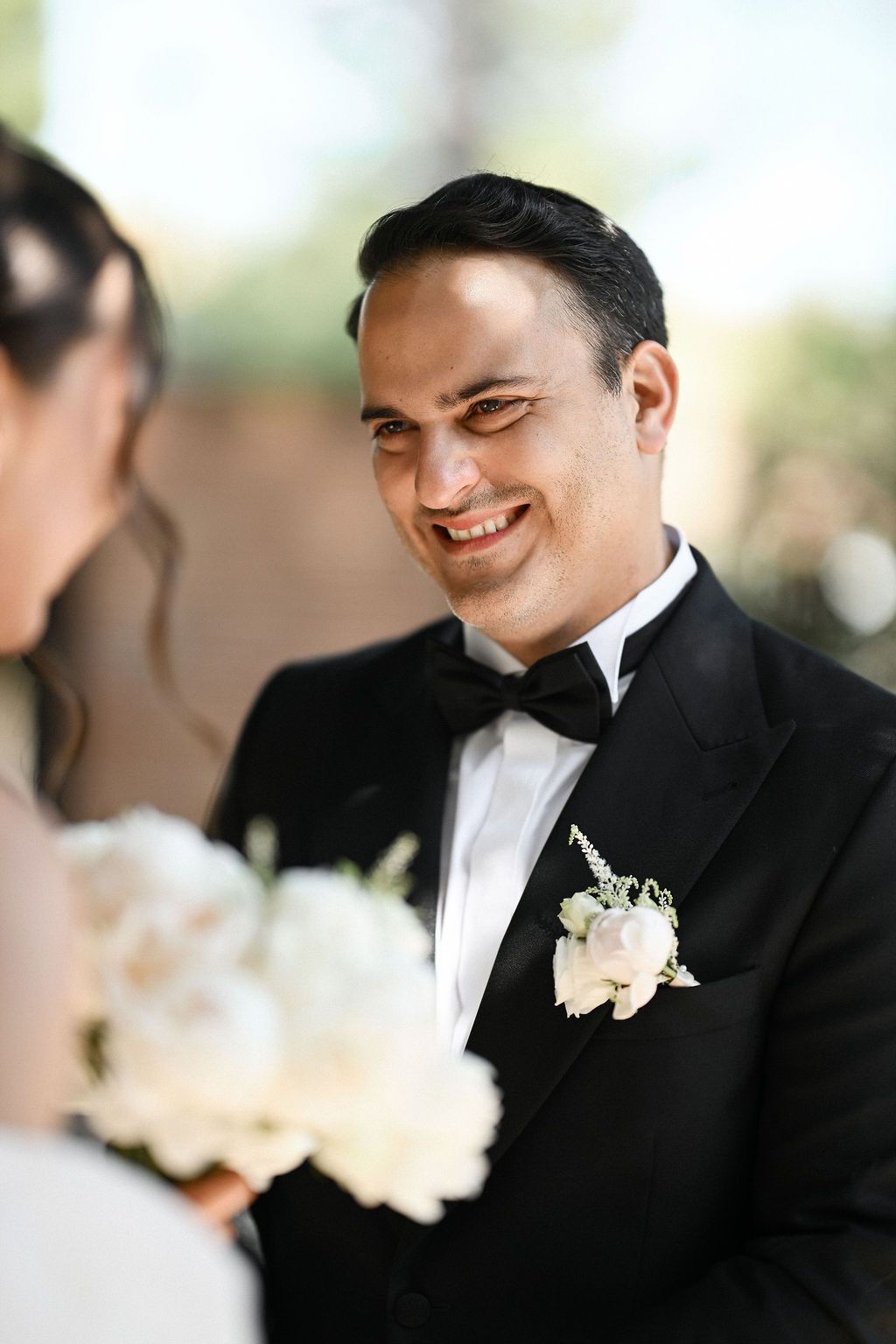 The groom's emotional and candid reaction upon seeing his bride in her wedding dress during their private first look at the villa.