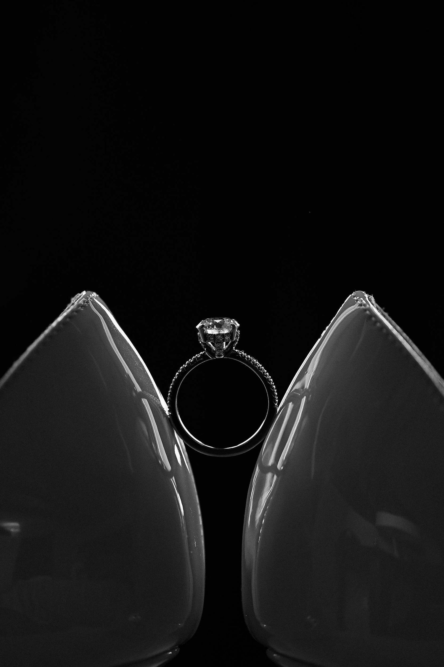 Macro shot of high-end wedding rings and bridal shoes, editorial detail photography by Darista at a historical Valencia venue.