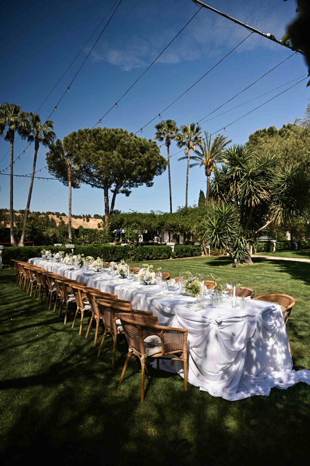 Straight reception table setup with elegant decor in Villa Paula garden. Intimate destination wedding dinner design by Darista.