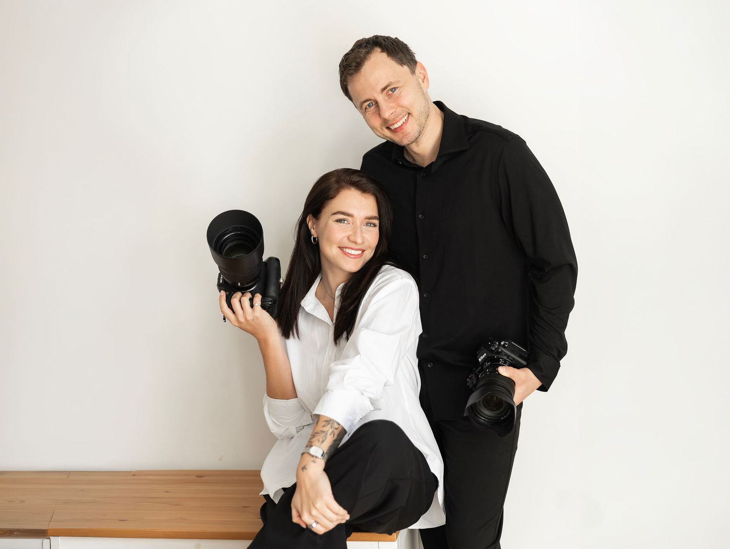 Yuri and Darina, Spain wedding content creators, smiling with gear to provide luxury vertical storytelling for high-end Valencia weddings.