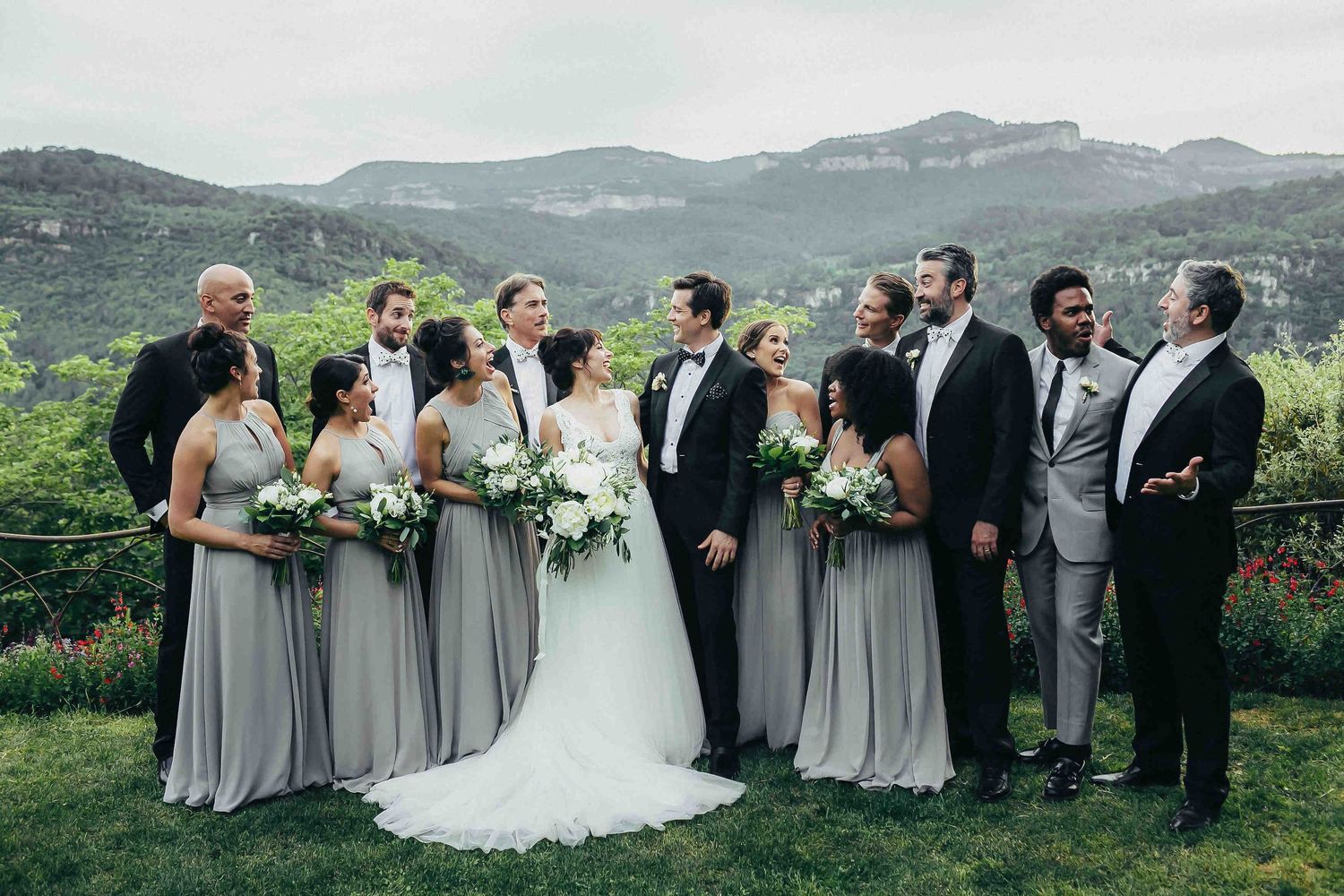 Destination wedding photographer in Spain. Groom, bride with bridesmaids and groomsmen in matching attire against mountain backdrop-Darista