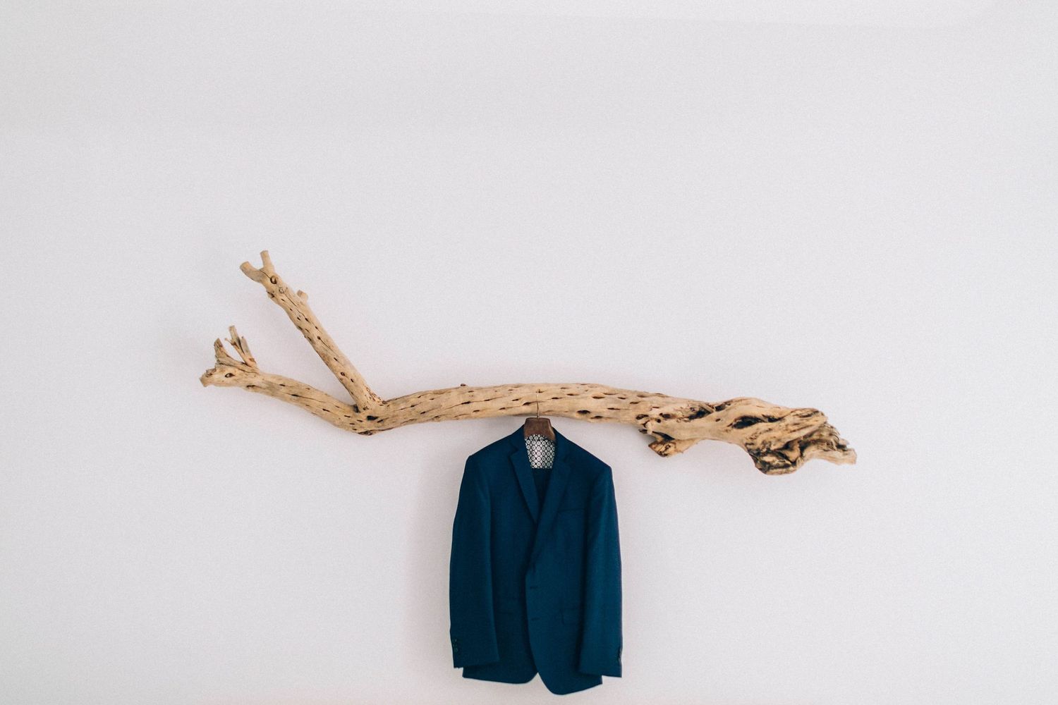 Candid shot of the groom suit jacket for the destination wedding