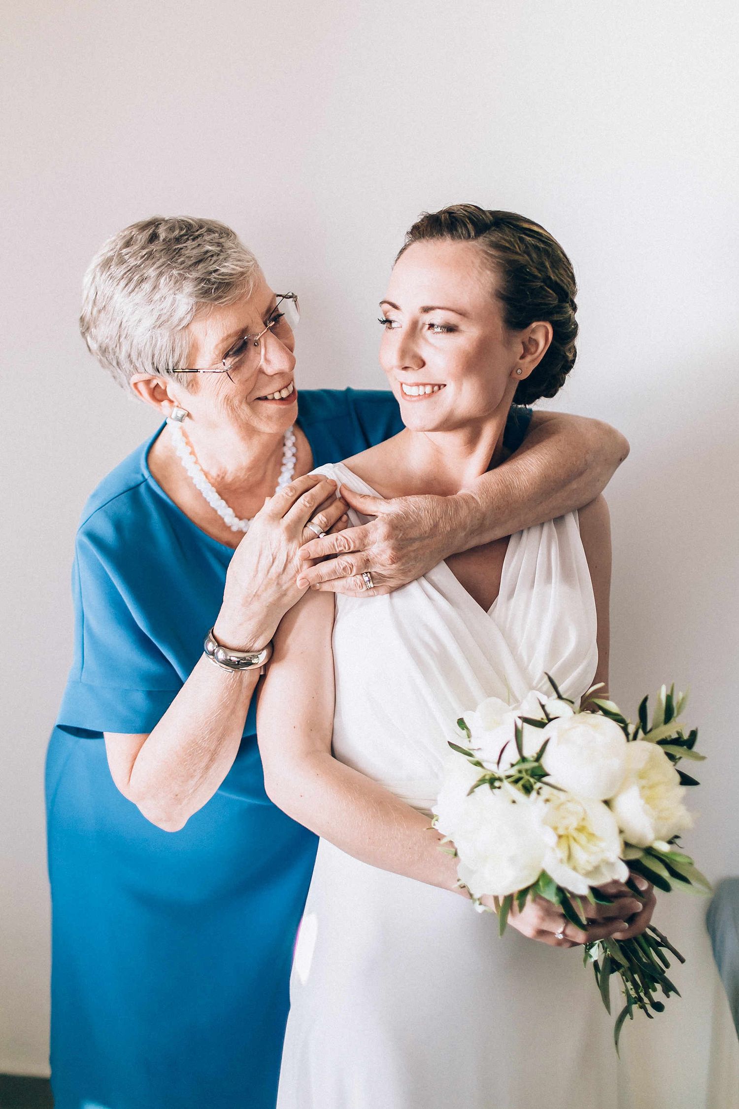 Beautiful portrait of the bride and her mother during wedding preparation in Greece